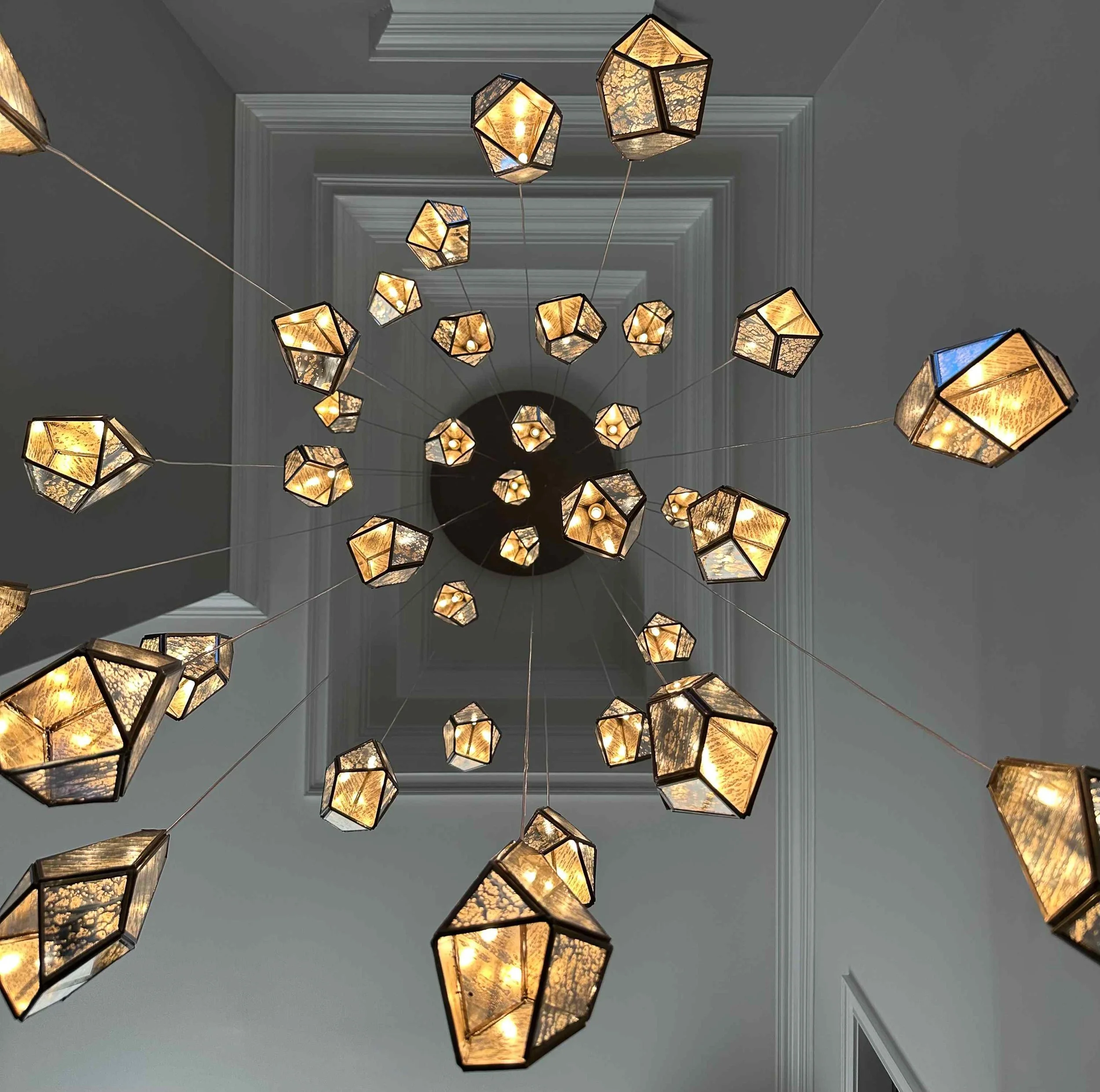 East Cobb luxury foyer overhead view of geometric gem multi-pendant chandelier radiating from coffered ceiling medallion, East Cobb, GA private residence, interior design by Luxe Style Studio