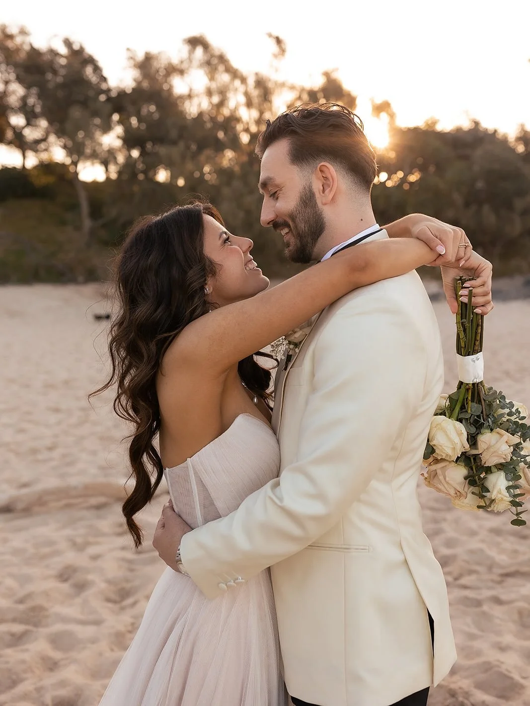 Sasha + Oliver barefoot in the sand soaking up that golden goodness ✨️⁠
⁠
Wedding suppliers:⁠
⁠
Photographer @figtreepictures⁠
Venue @osteriaweddings⁠
Florist @articfox_events⁠
Content creator @allureaisle⁠
Dress @evieyoungbridal⁠
Suit @institchu⁠
Ha