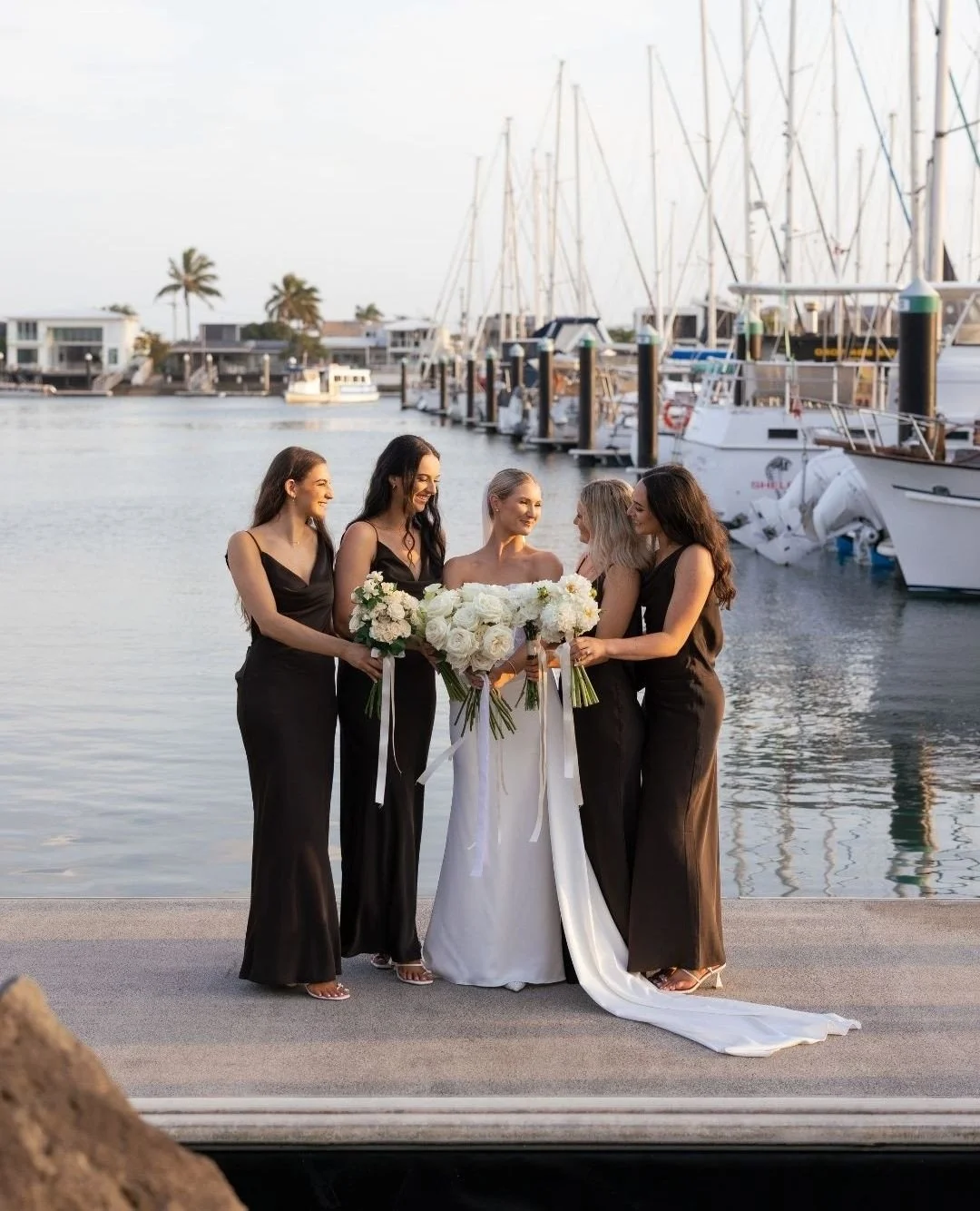 What a setting for this gorgeous wedding party 🤍 Congratulations Emily + Lachlan!⁠
⁠
Photographer @figtreepictures⁠
Venue @pier33mooloolaba⁠
Celebrant @ceremoniesbybernadette⁠
Florist @wylde_magnolia_x⁠
Videographer @brisbanevideocompany⁠
Dress @mad