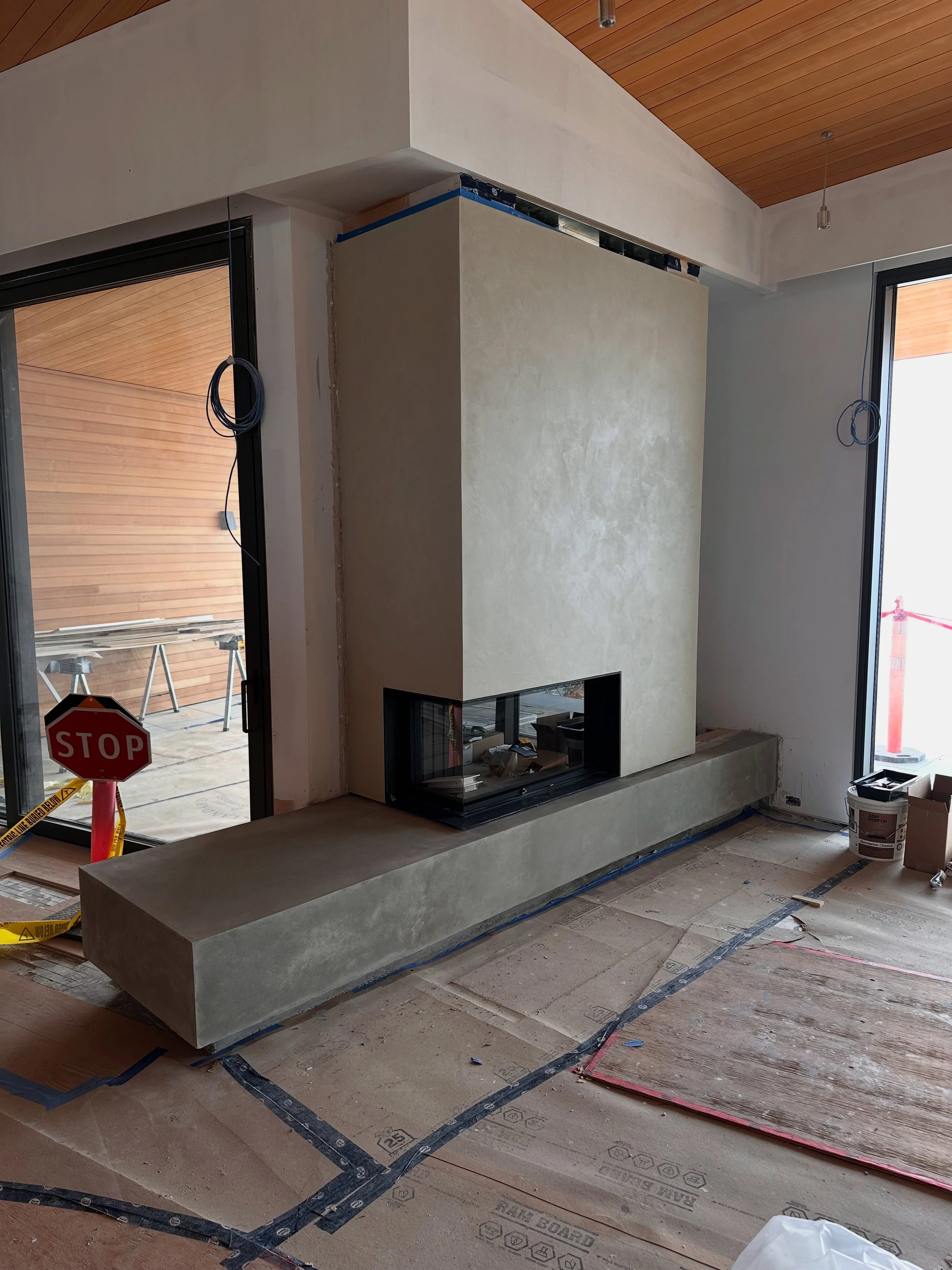 Marmorino Classico lime plaster fireplace, crafted with an organic, hand-applied finish that enhances the space with warmth and timeless elegance. The subtle variations in texture create movement and depth, giving the surface a natural character that
