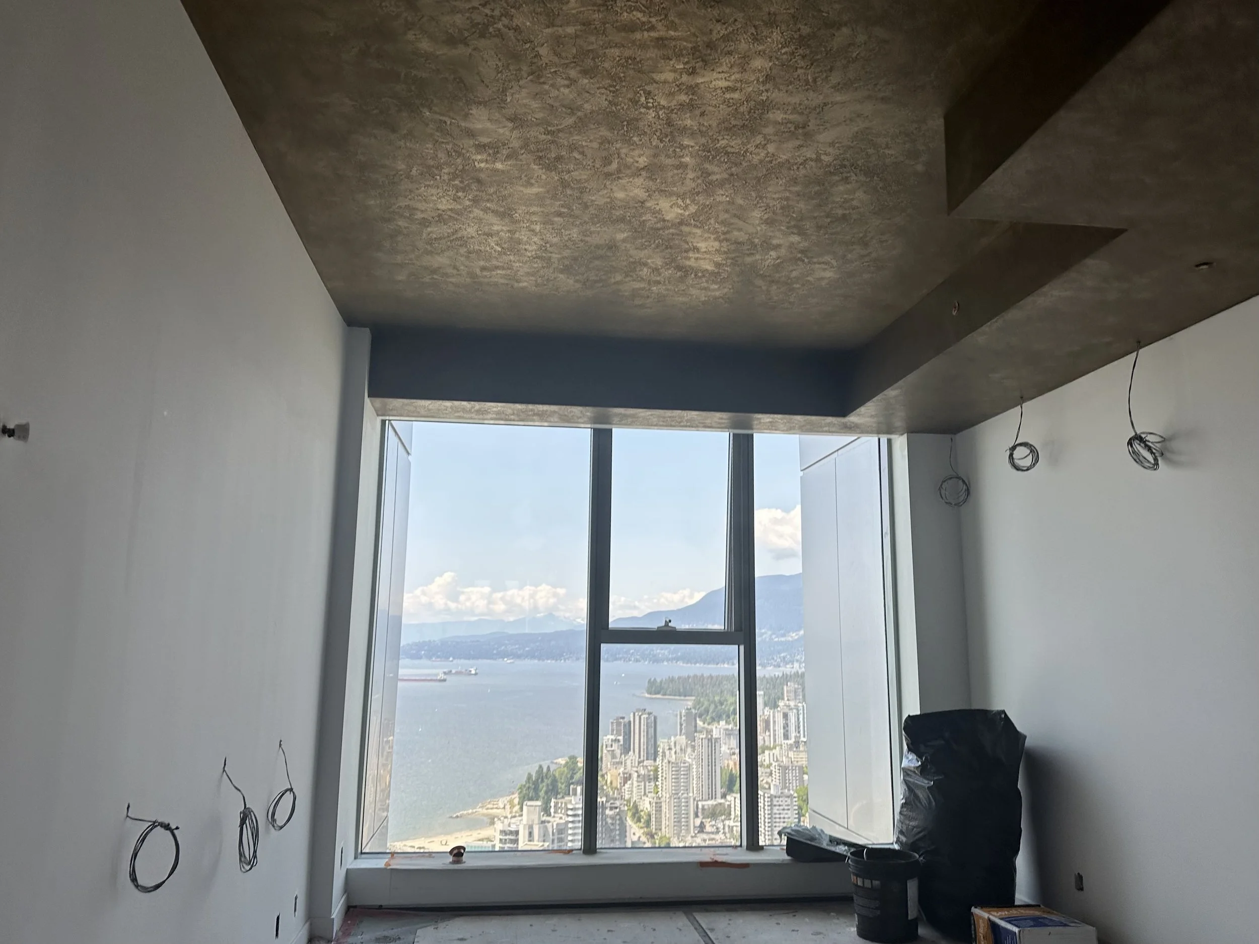This ceiling is crafted from 100% bronze, brass, and stainless-steel Liquid Metal (LMFX), finished with a trowel-overlap pattern. The result is a striking, reflective surface with sculptural depth and a dynamic, tactile quality that elevates the enti