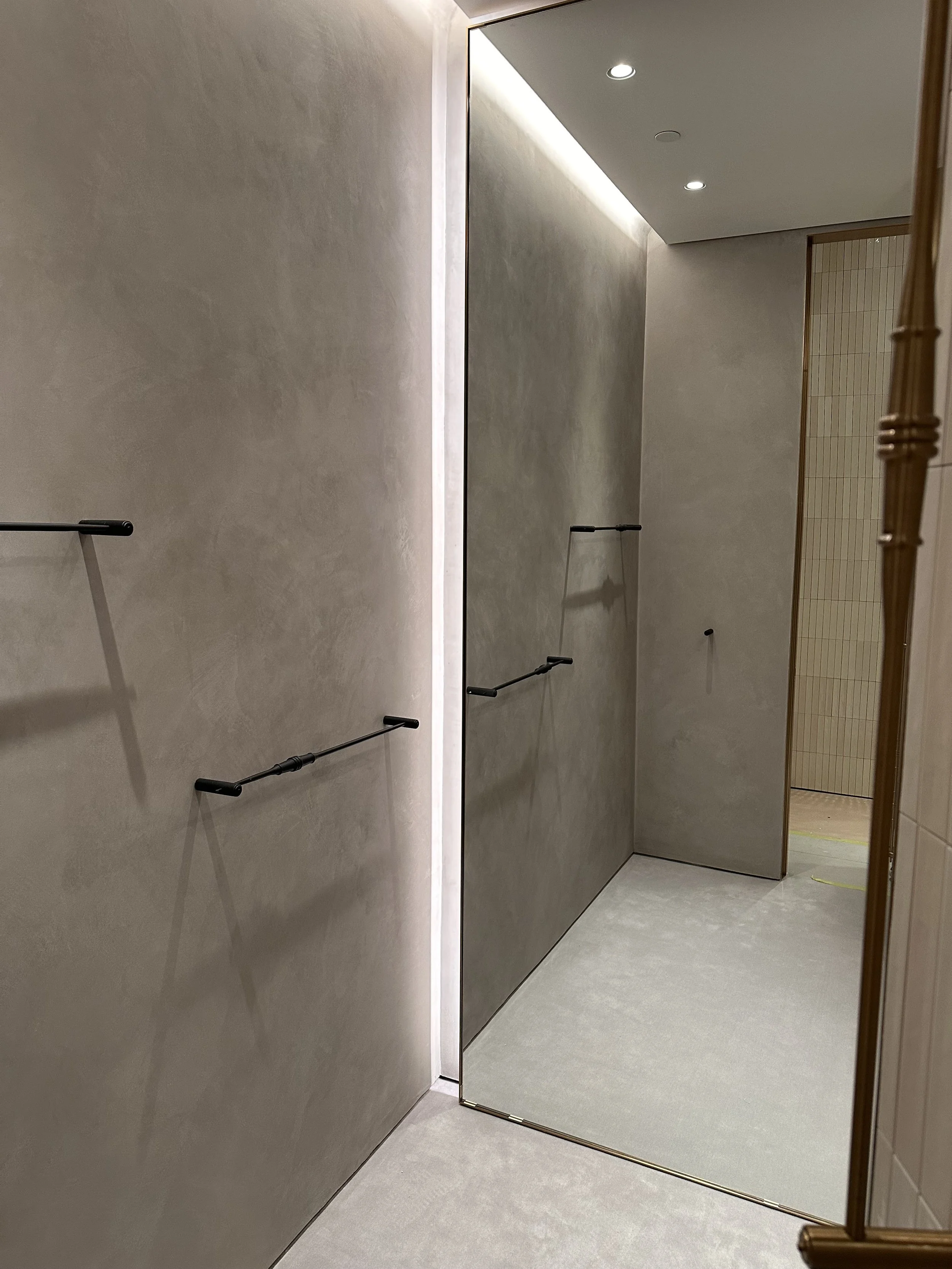 The Loewe fitting rooms were finished in a refined Marmorino Fine plaster, creating a smooth, elegant surface with subtle movement and depth. This traditional lime-based finish enhances the sophisticated aesthetic of the space while maintaining a tim