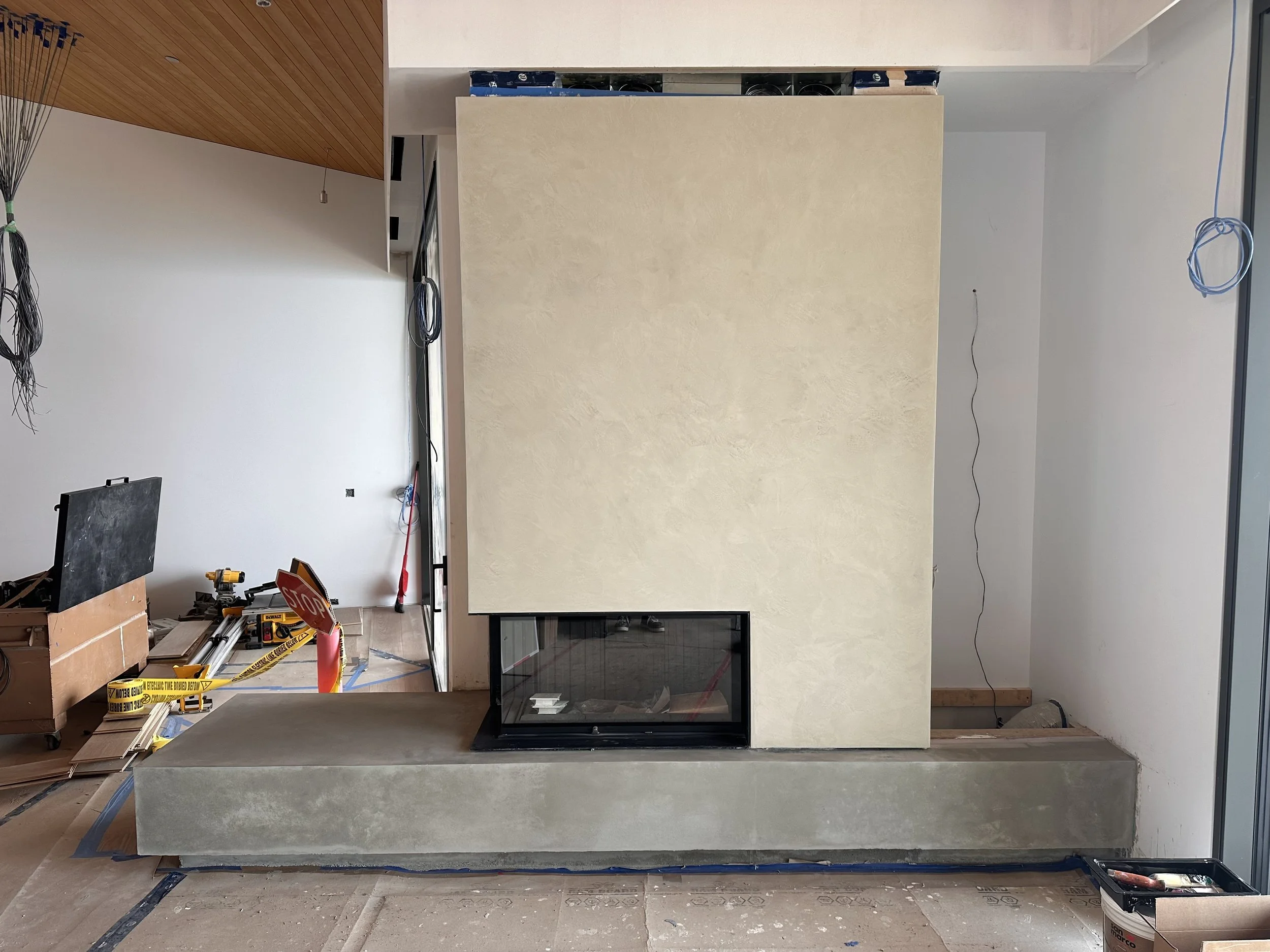 Marmorino Classico lime plaster fireplace, crafted with an organic, hand-applied finish that enhances the space with warmth and timeless elegance. The subtle variations in texture create movement and depth, giving the surface a natural character that