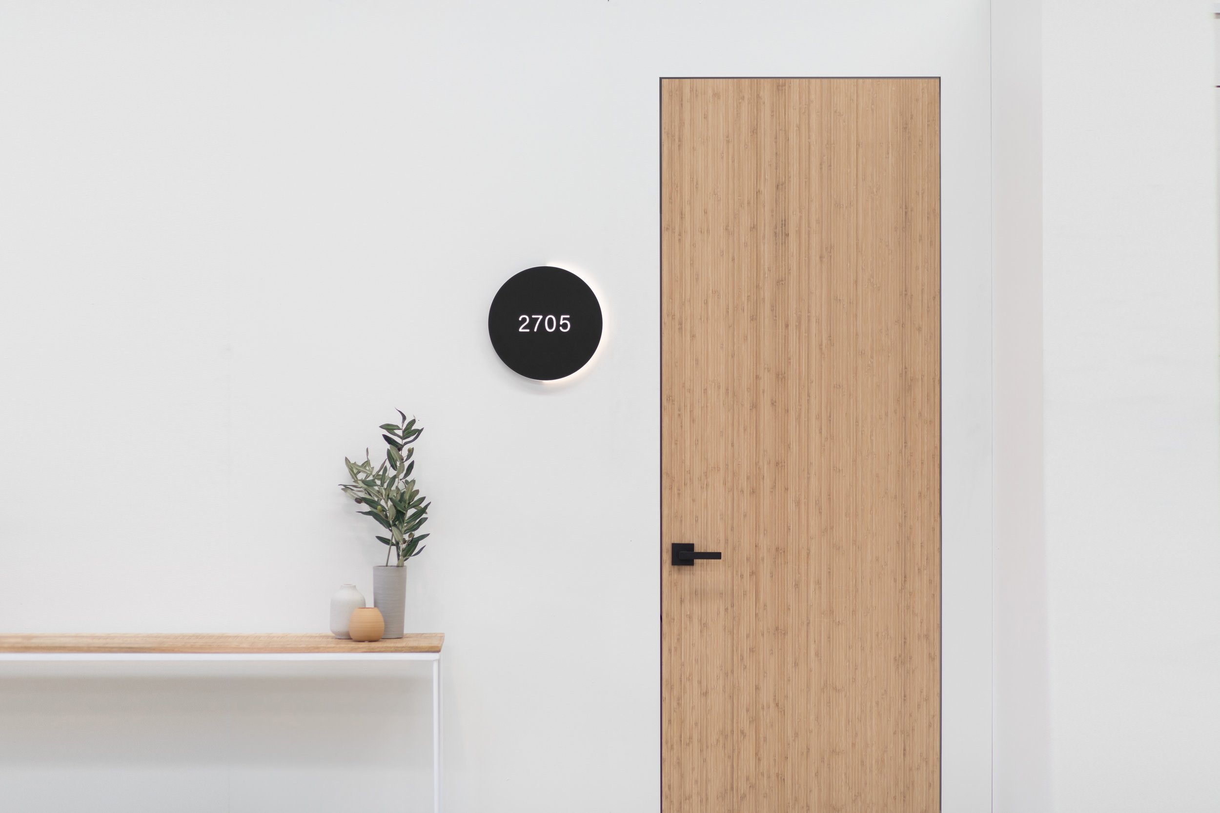 Luna is a wayfinding scheme inspired by the motion of the moon crossing the path of the sun in a solar eclipse. LED illumination on one side of the main room signs is used to indicate the direction of travel, with subtle strokes of illumination used