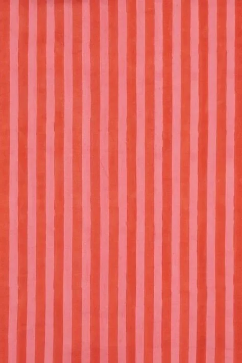 Vertical pink and red striped pattern on fabric or paper