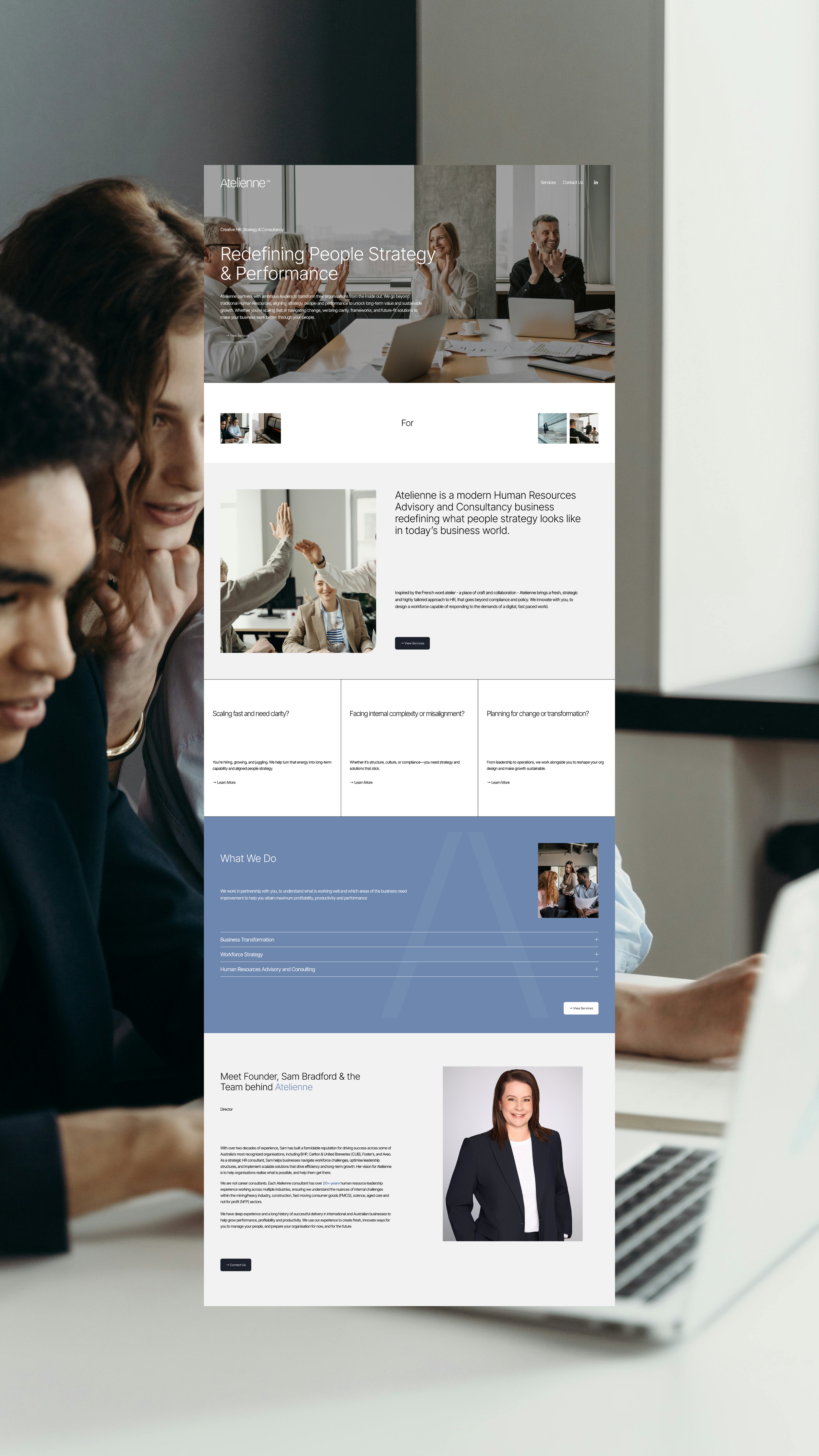 Website on a computer screen showing a business consulting company's homepage, titled 'Redefining People Strategy & Performance', with images of professionals and sections about services and team members.