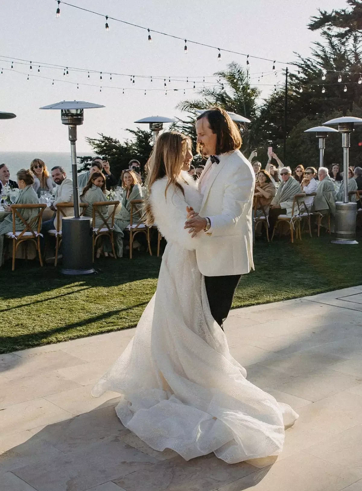 malibu wedding reception with bride wearing fur coat!