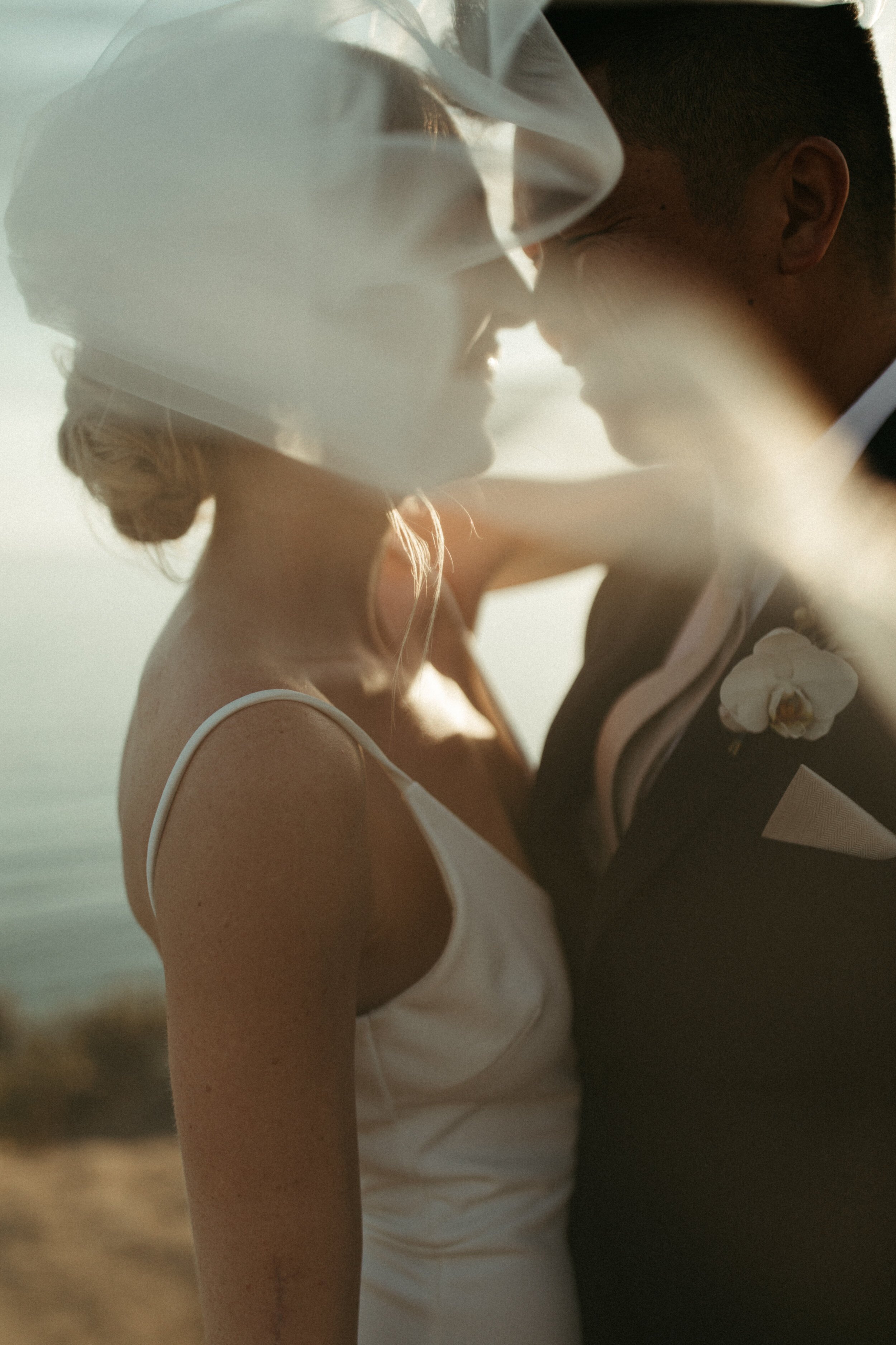 wedding photos near the ocean with bride's veil in the wind (Copy)