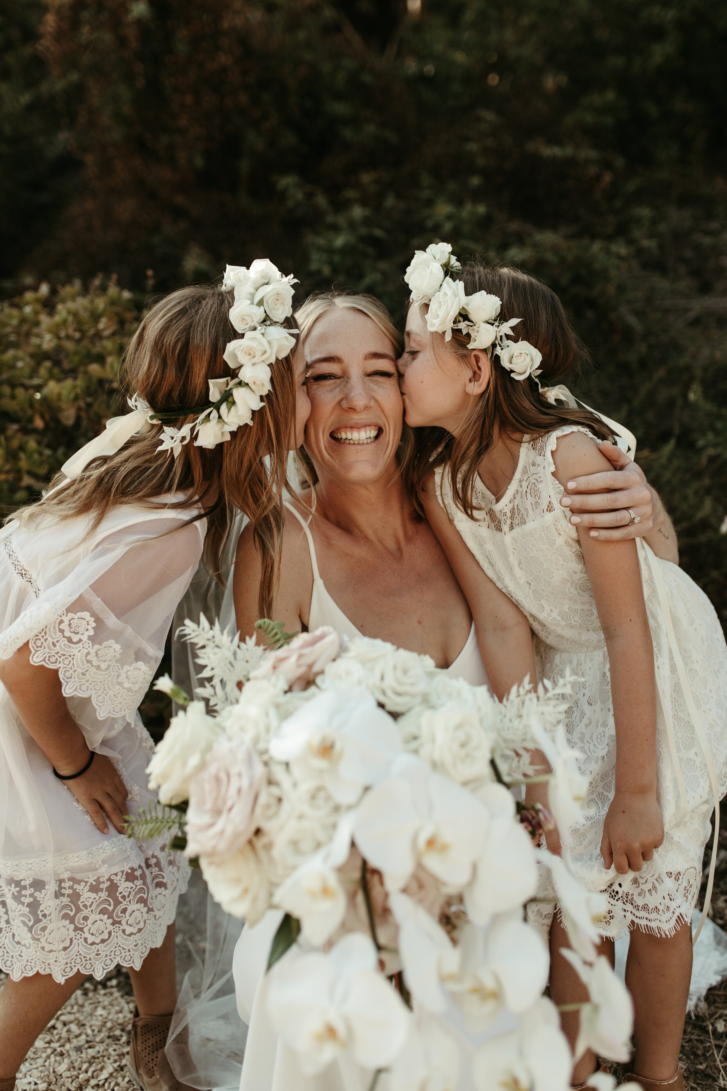 bride and flower girls huddle together for photo (Copy)