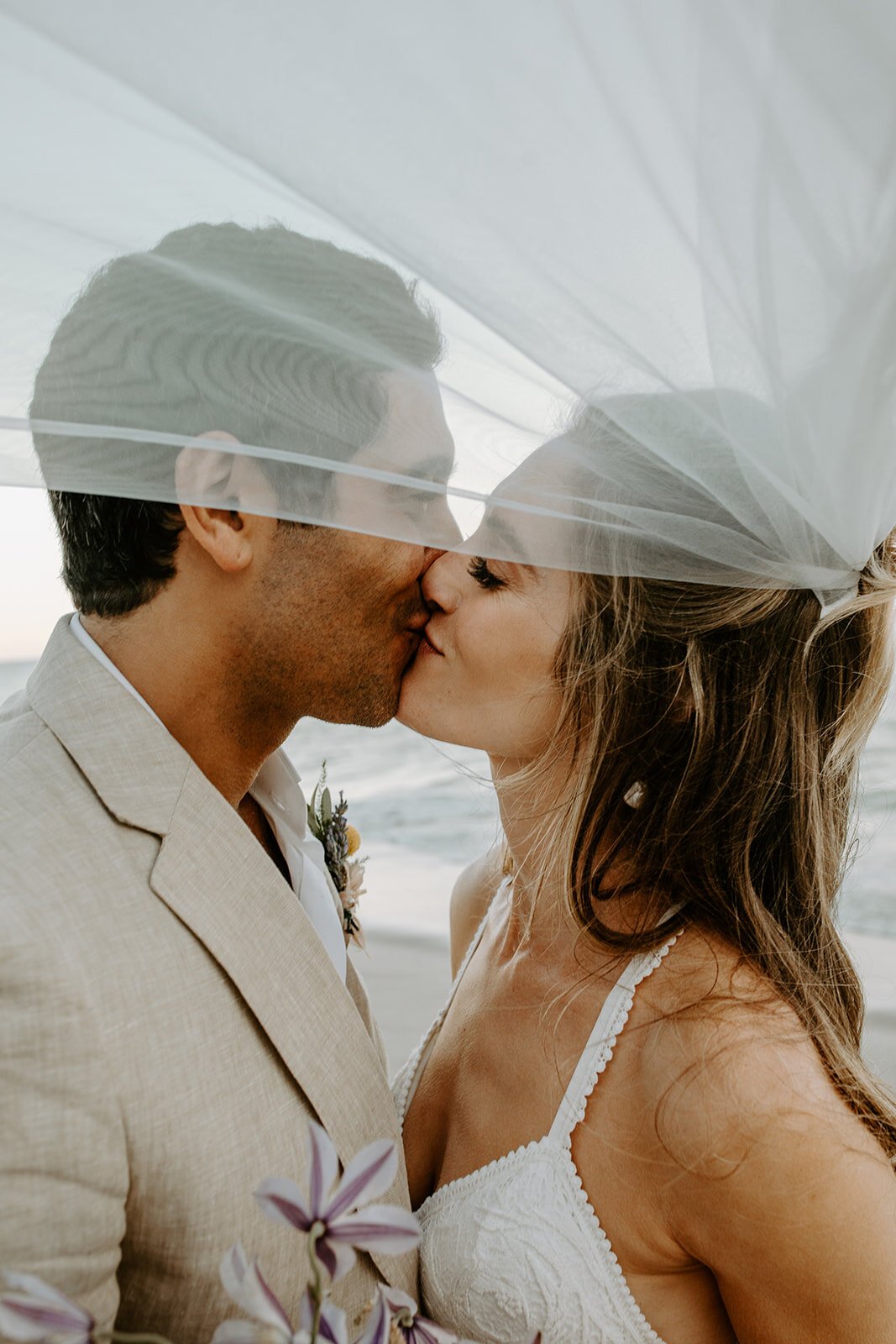 bridal portraits on the beach with veil flowing in the wind (Copy)