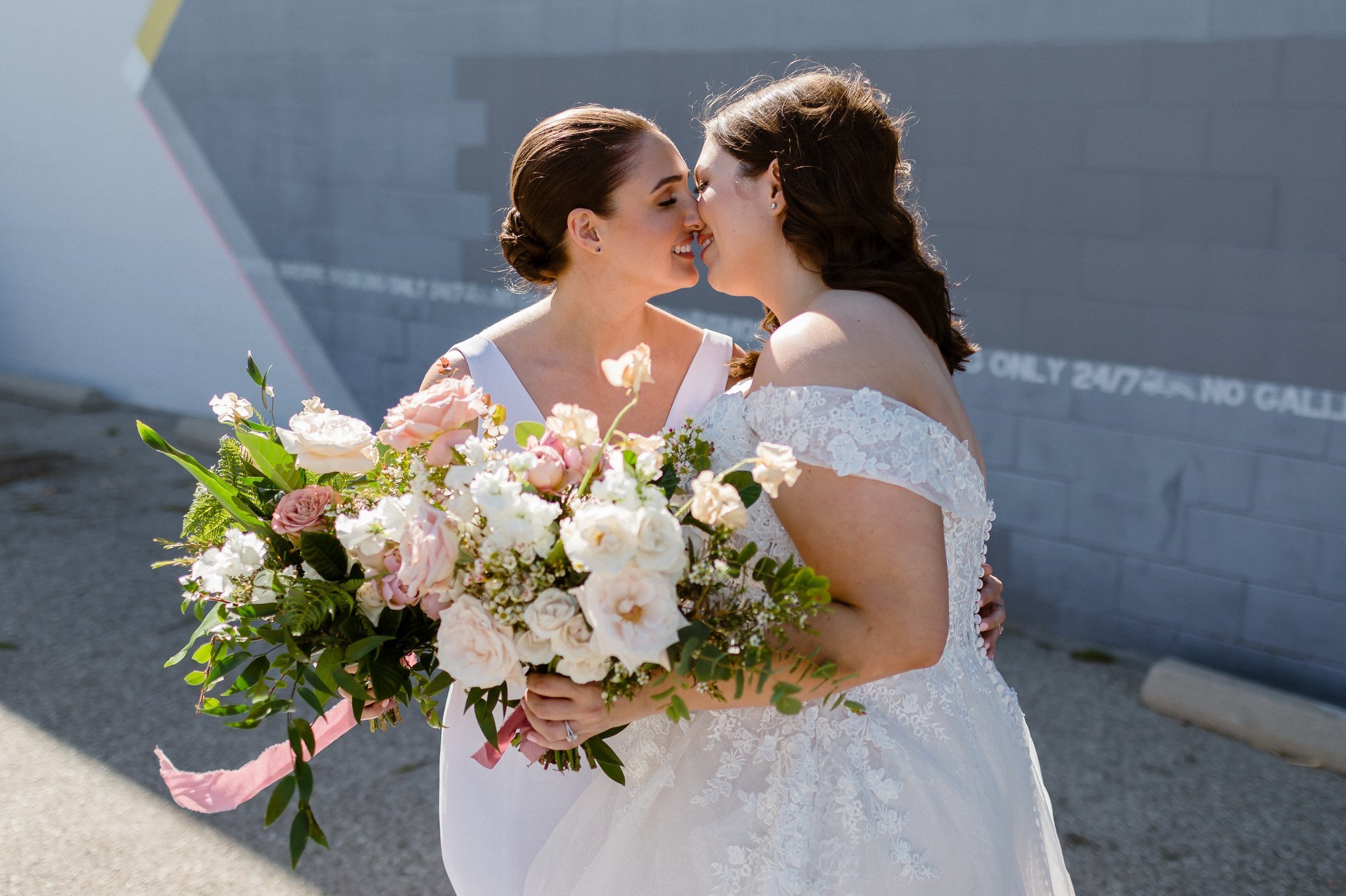 bridal portraits in front of colorful wall