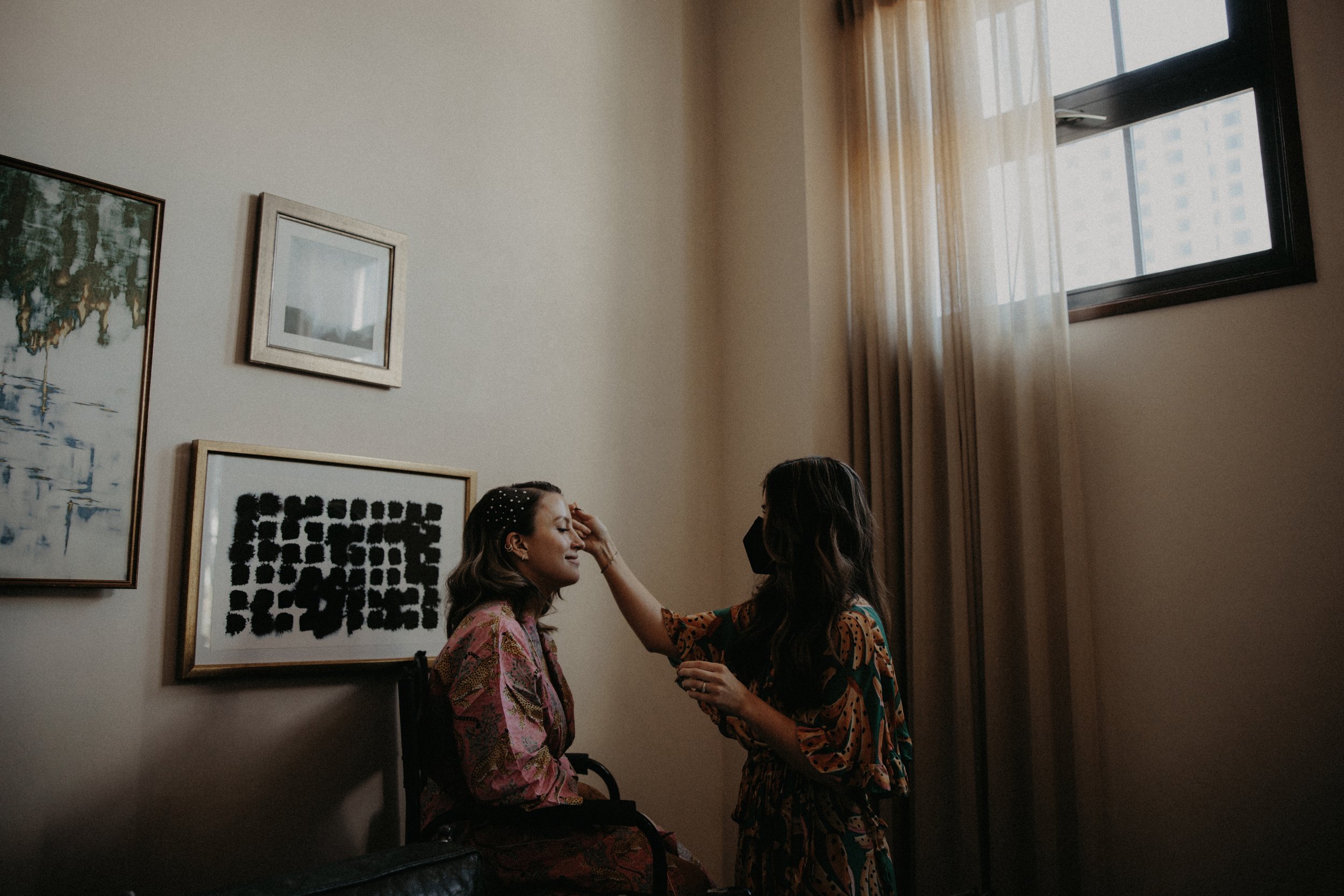 bride gets hair and makeup ready for her downtown los angeles wedding