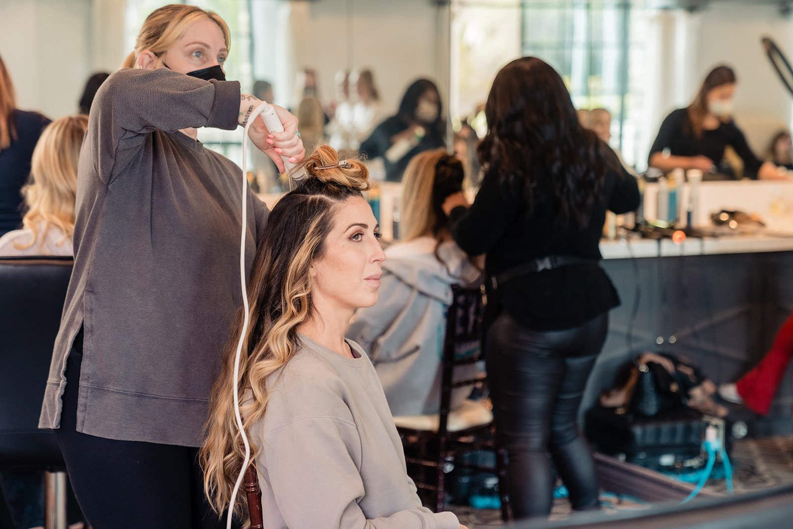 hair stylist creates boho and elegant hairstyle for wedding party at bel air bay club in pacific palisades