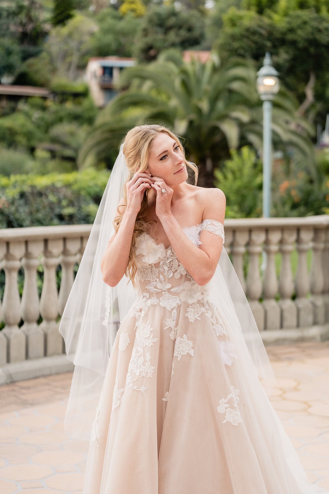 bride getting into her wedding gown before her malibu coastline wedding