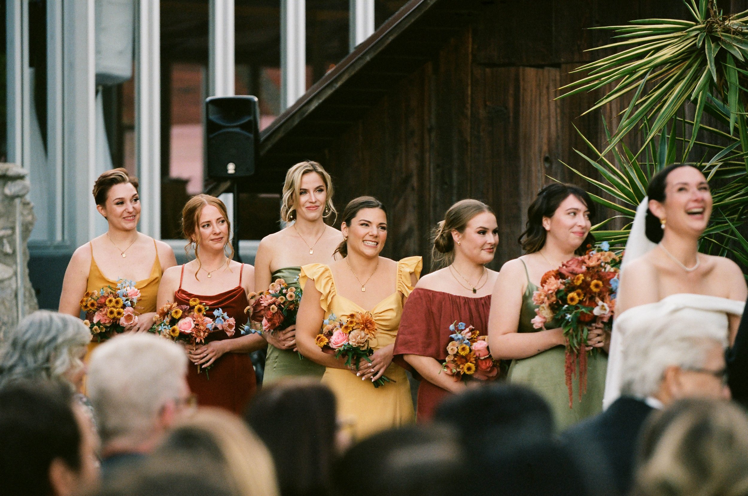 bride and bridesmaids glow with joy at the los angeles wedding ceremony at stonehurst