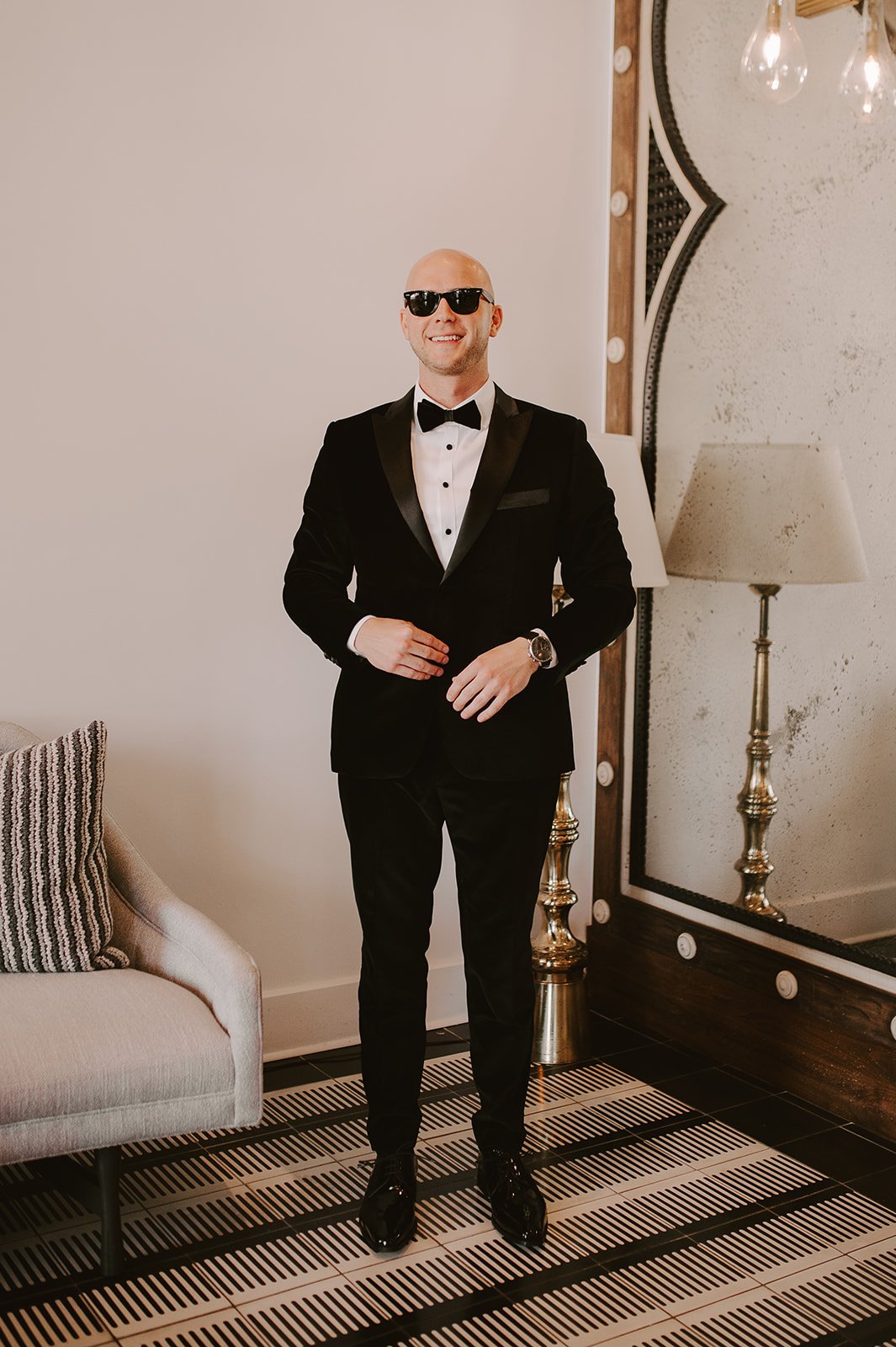 groom in black tie with sunglasses before his santa barbara wedding