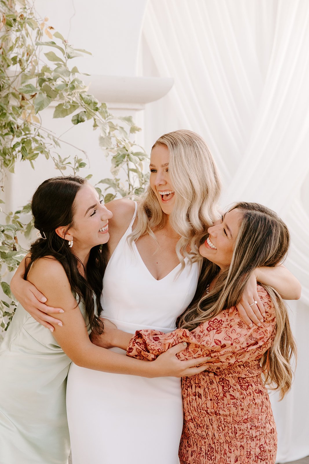 bride hugs her bridesmaids at her santa barbara wedding reception at villa and vine