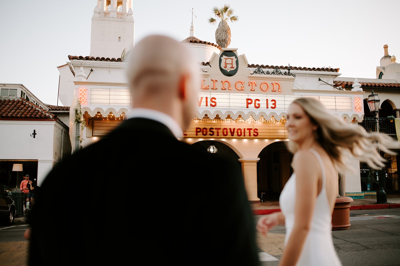 couple walk the streets of santa barbara after getting married at the courthouse