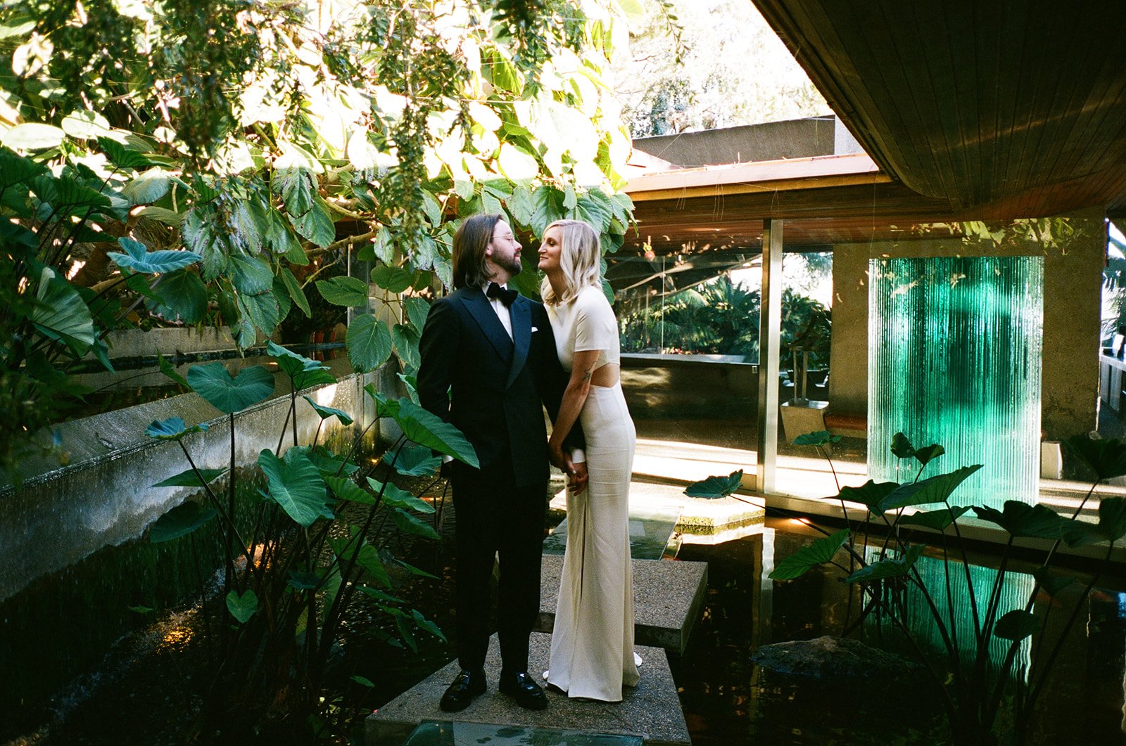 photographer takes film photos of the bride and groom at the iconic Sheats–Goldstein Residence in beverly hills