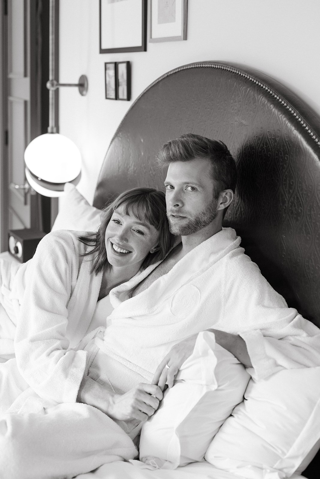 LA bride and groom wear robes and lounge in bed before their elopement