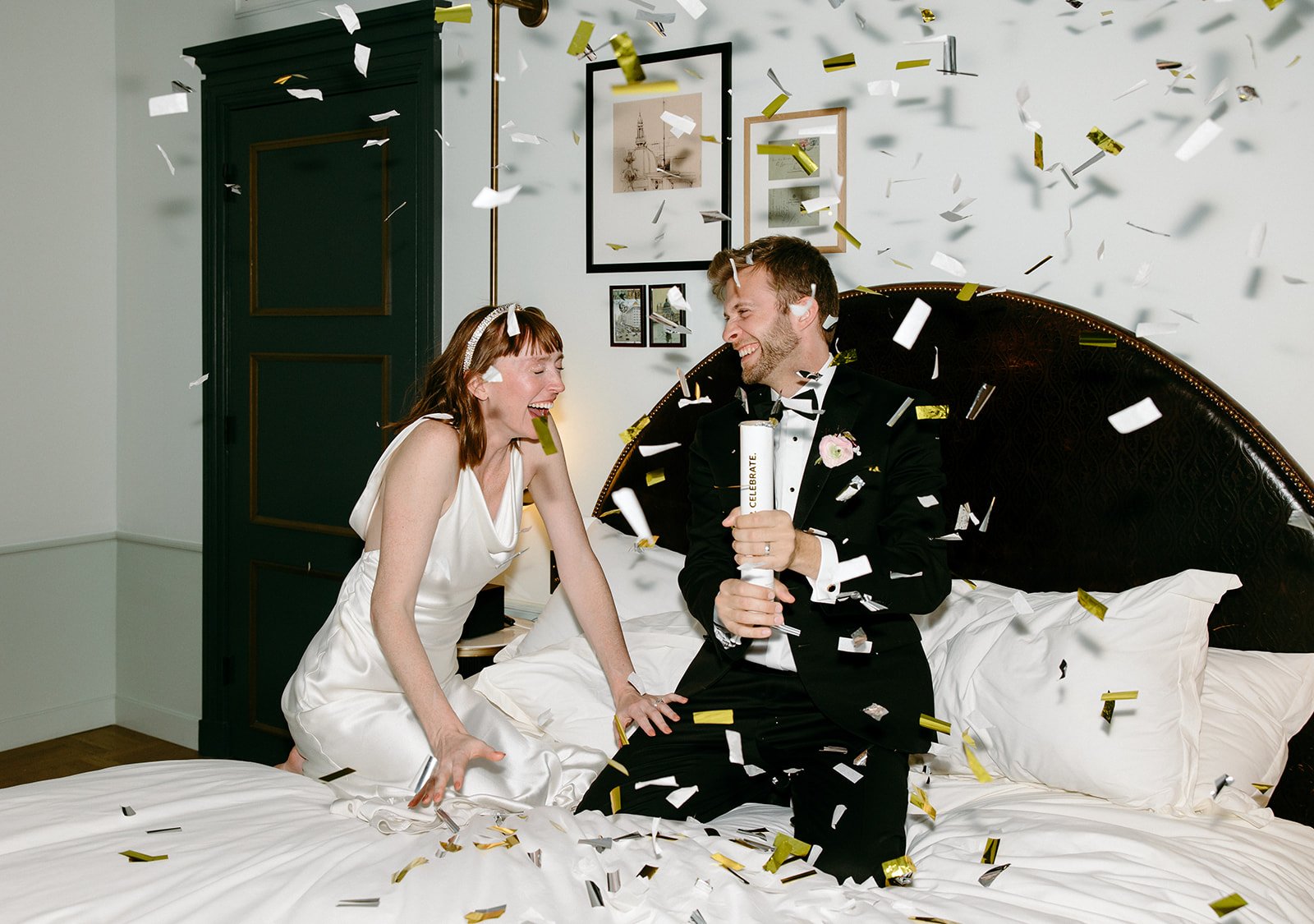 flash photos capture bride and groom throwing confetti around their hotel room