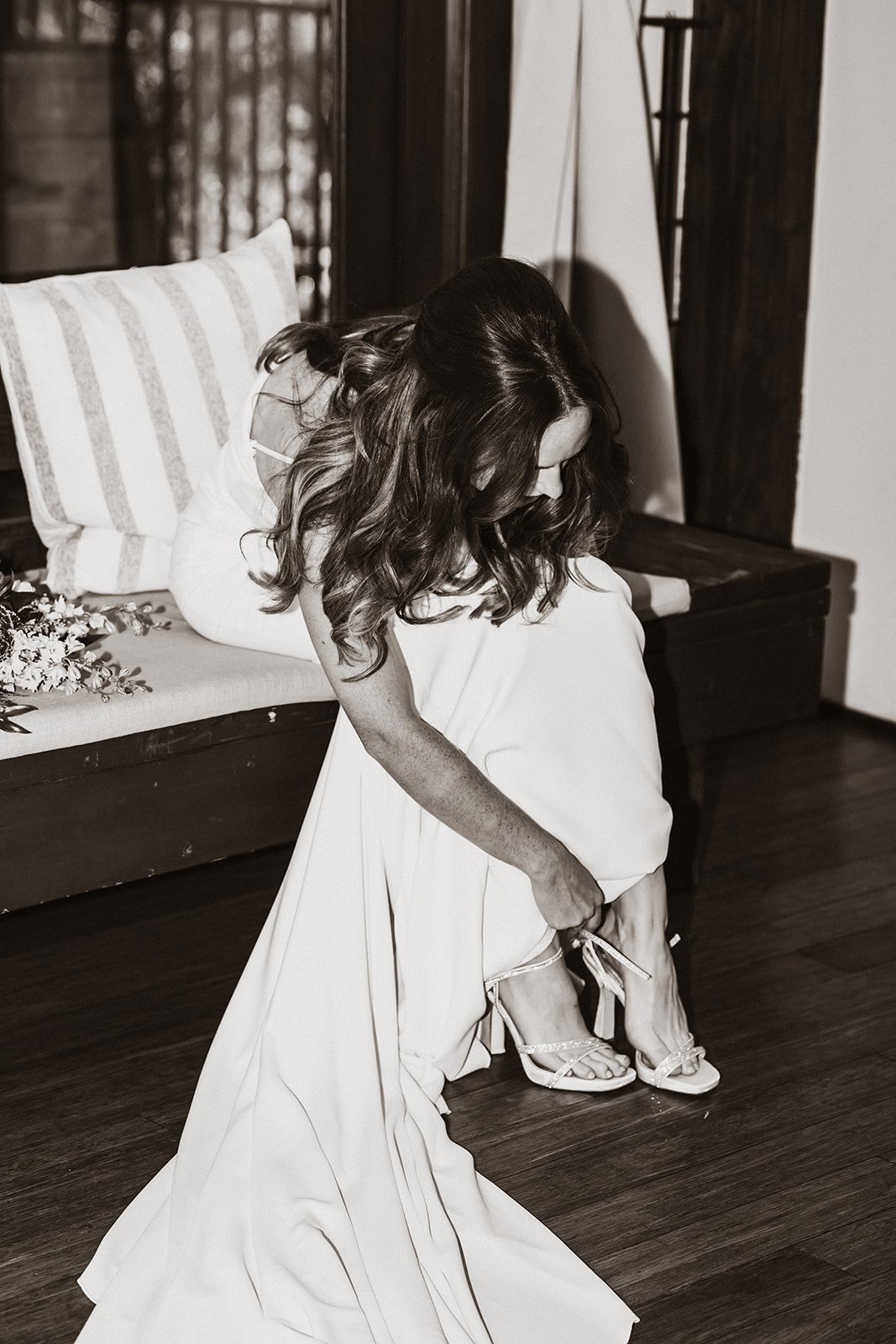 bride puts on her shoes before her wedding ceremony in topanga canyon