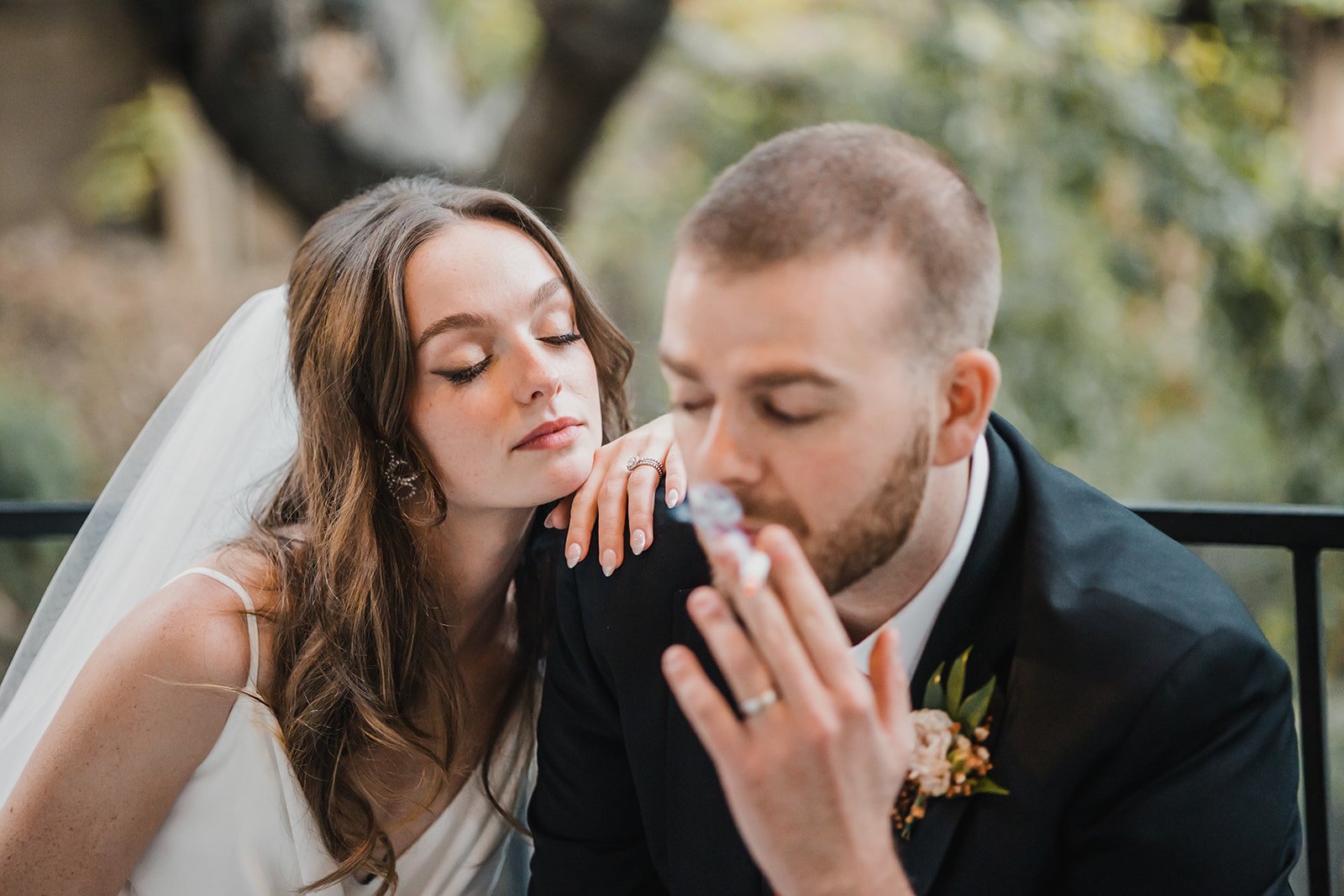 bride and groom smoke before their wedding ceremony in southern california