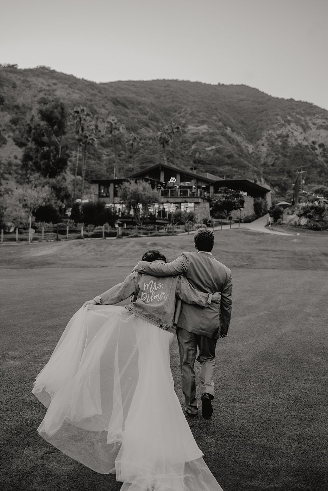 bride wears custom jean/denim jacket for her wedding reception