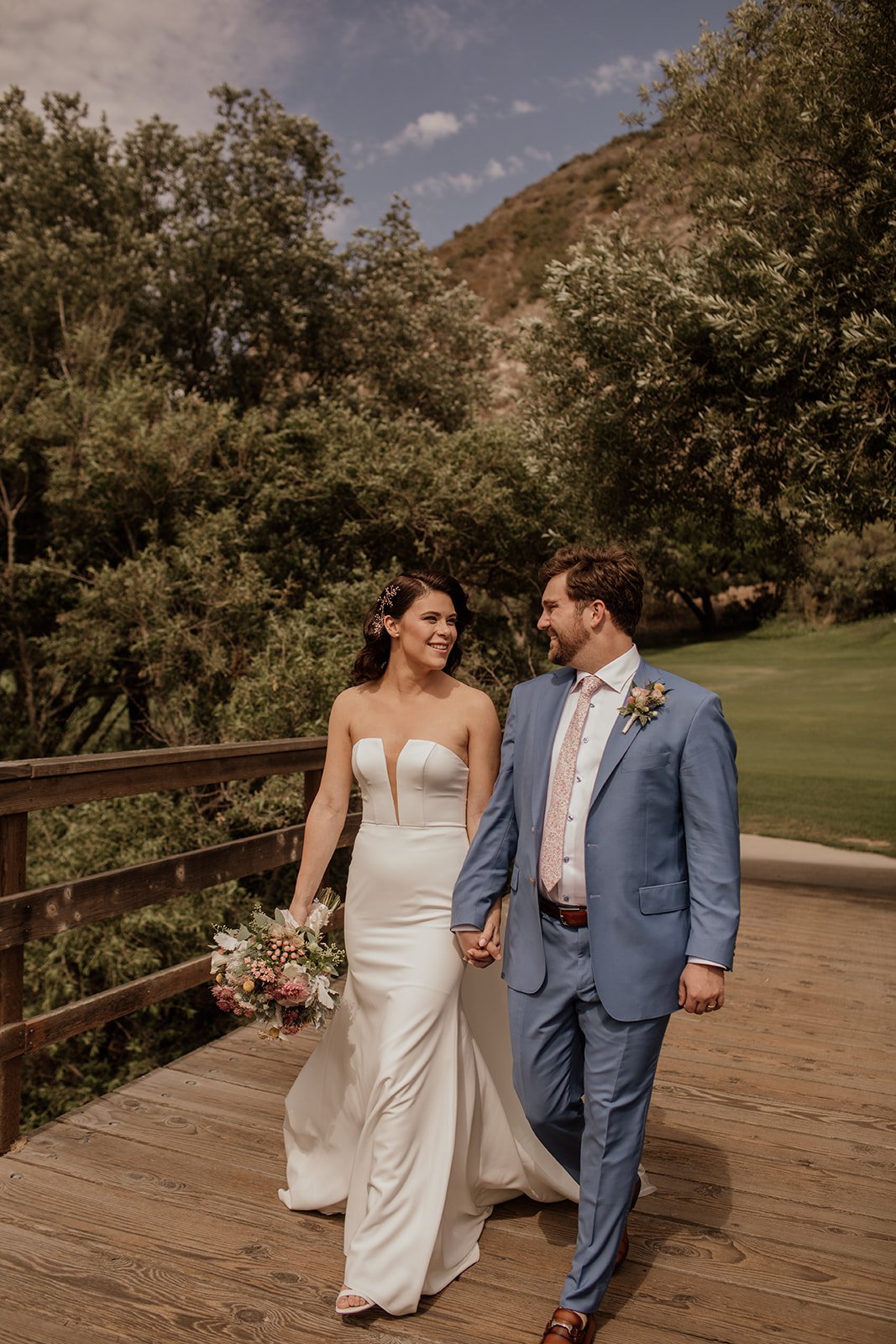 bride and groom walk about their wedding venue for bridal portraits in laguna beach