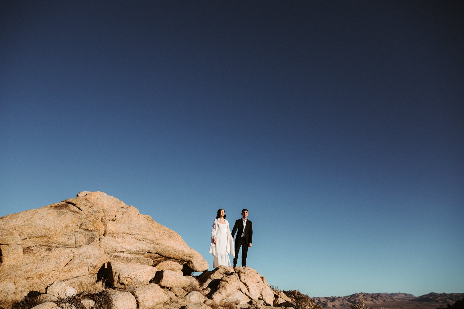 bride and groom take artsy photos after their elopement wedding ceremony in joshua tree