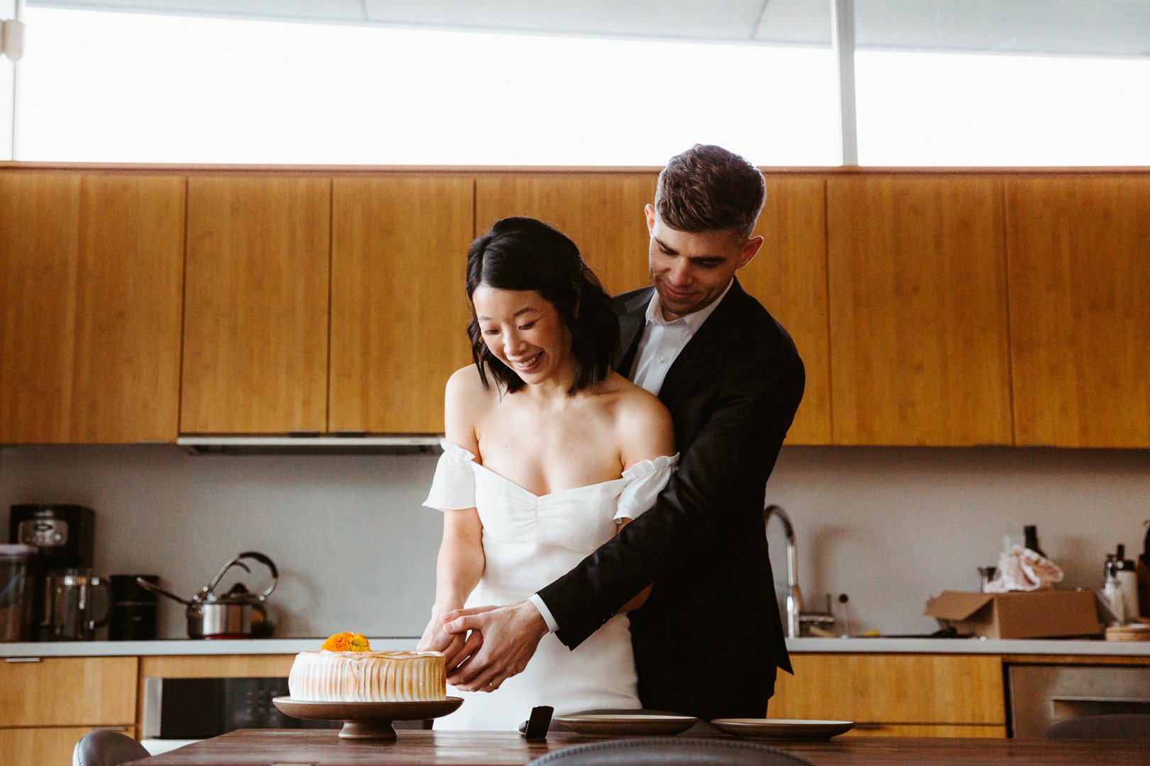bride and groom cut the cake after their wedding ceremony