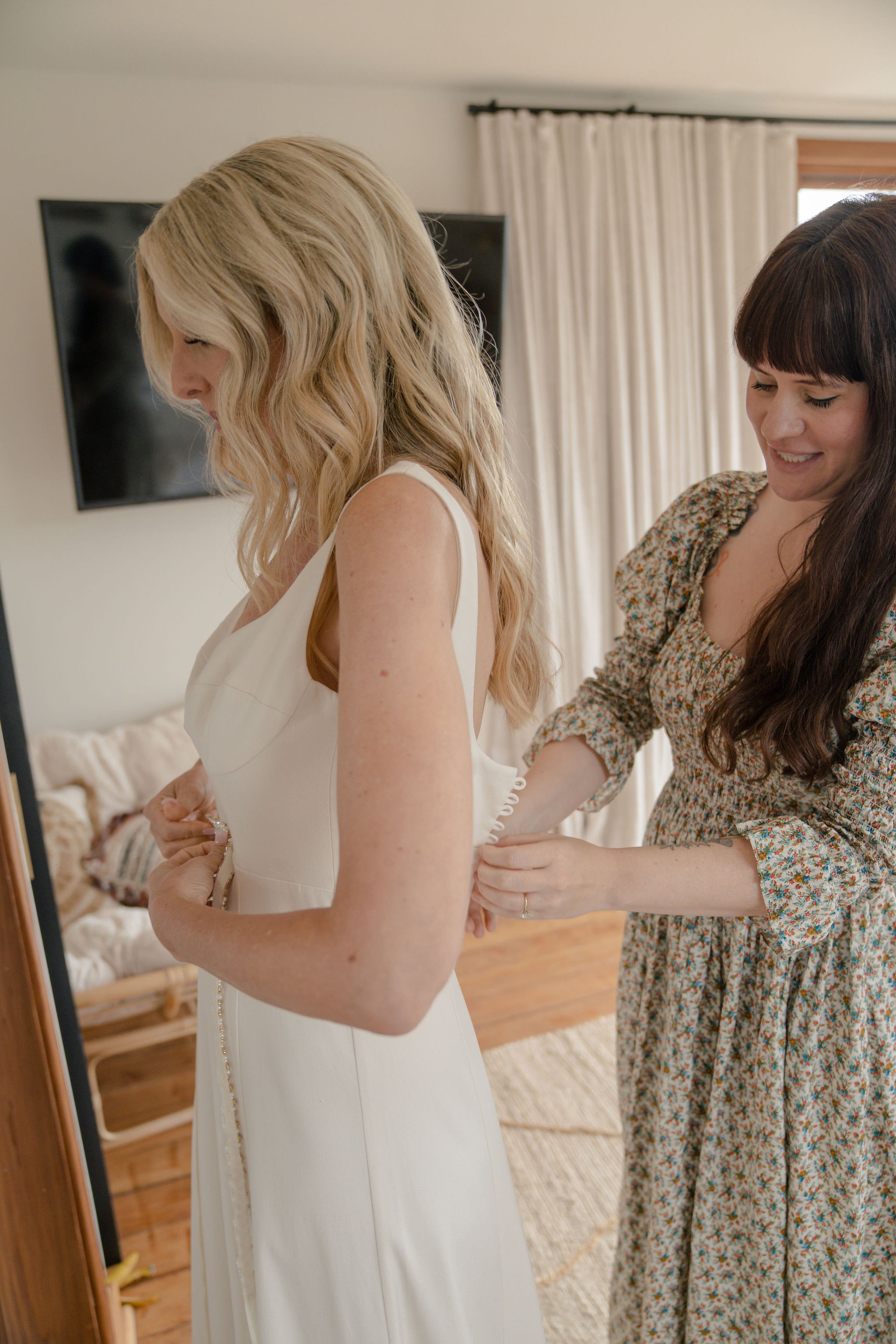 bride gets into her wedding gown at her topanga airbnb
