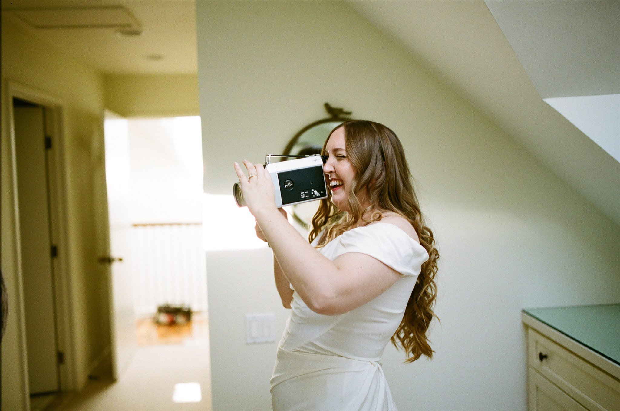 bride takes super8 footage of guests on her wedding day