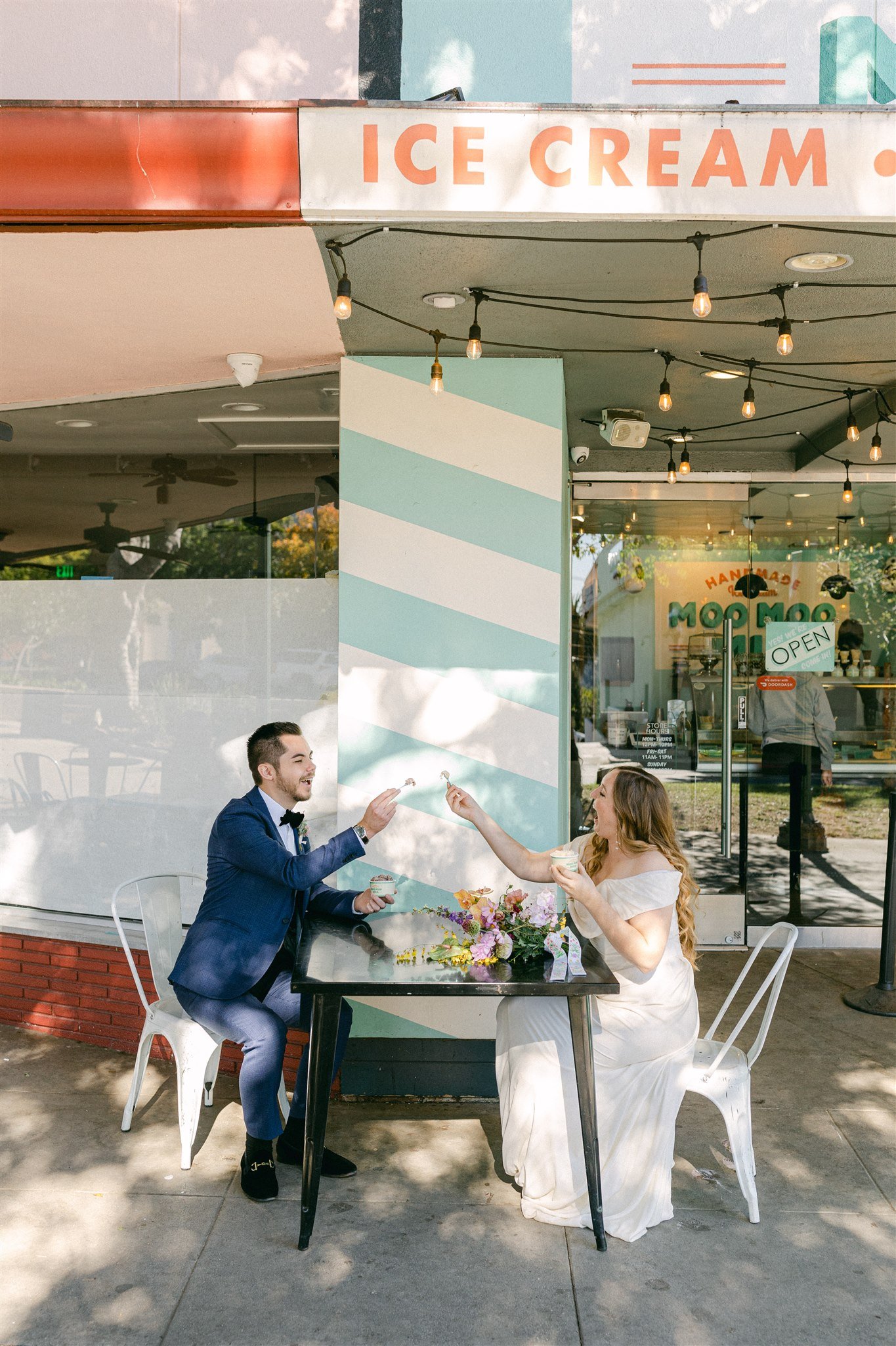 couple goes to local ice cream parlor on the day of their wedding