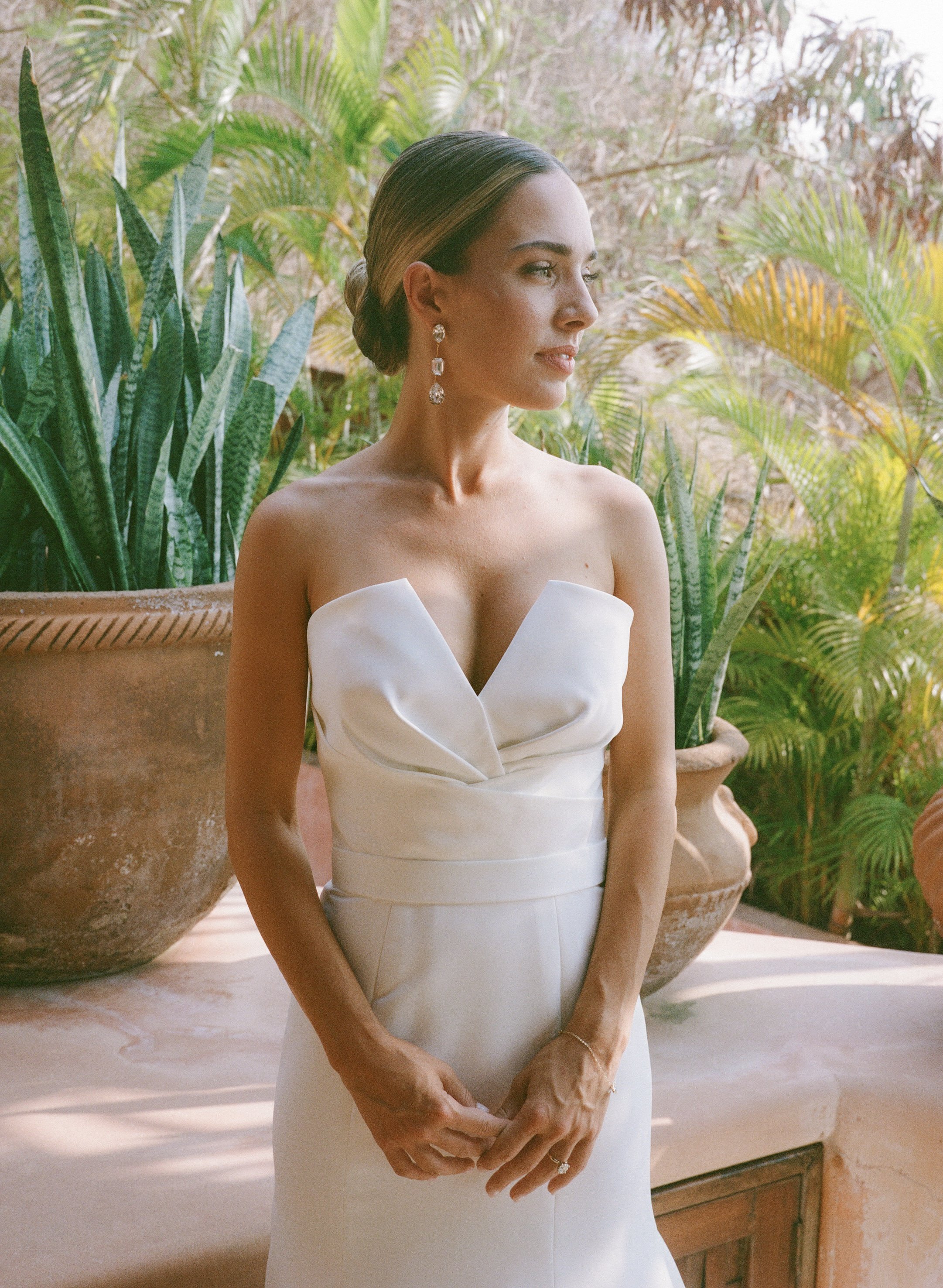 bride's hairstyle was a chic and slicked low bun with natural and flawless airbrush makeup