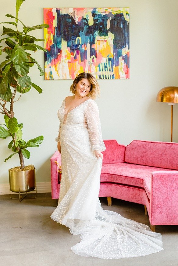 bride with her venue's pink sofa 