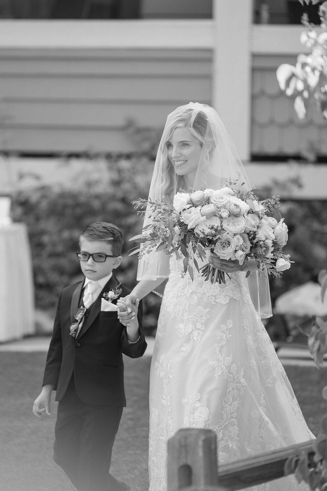 bride walks down the aisle with her son