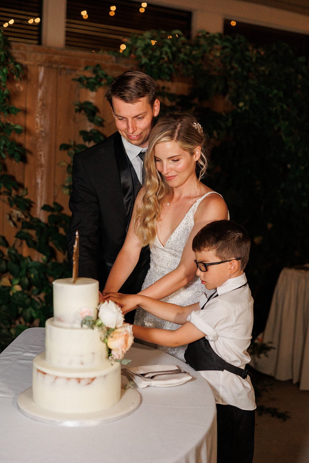 family cake cutting at this bride and groom's wedding reception in southern CA
