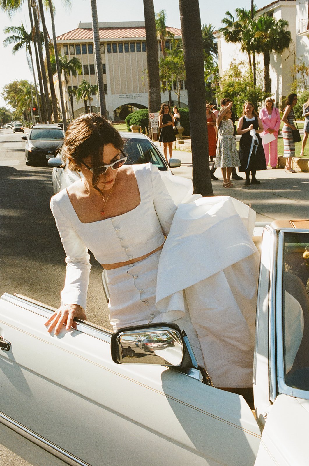 brides' drive off in their vintage convertible after their santa barbara wedding ceremony