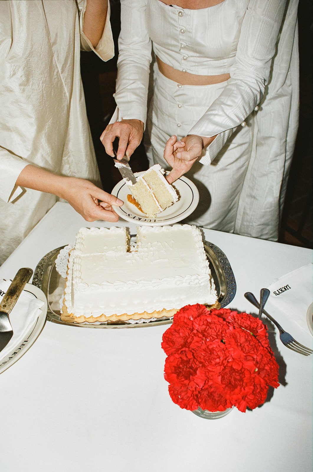 brides cut the cake at their santa barbara wedding