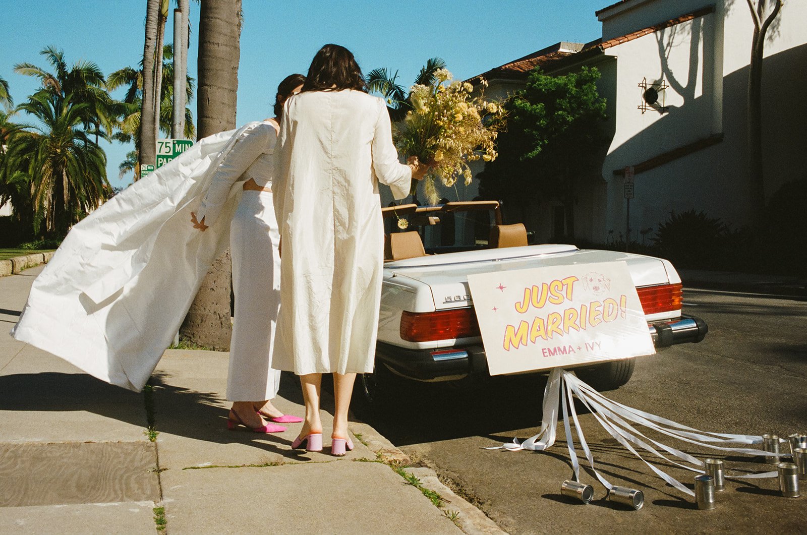 brides drive off in their vintage mercedes convertible after their wedding