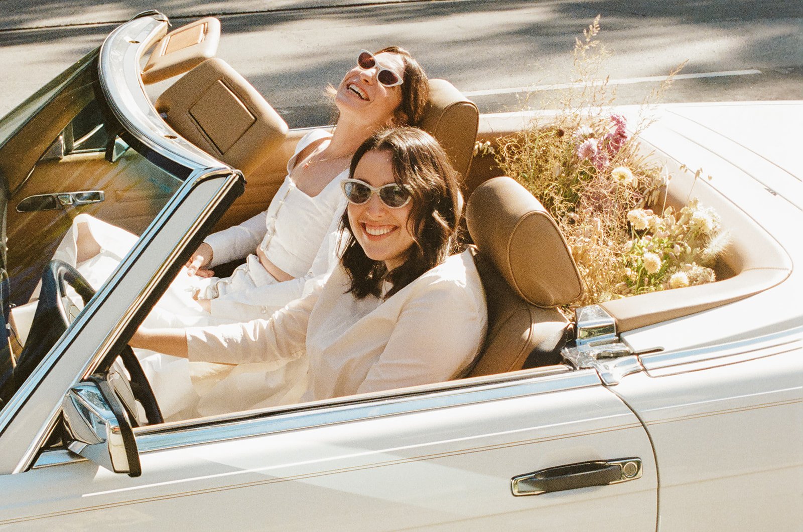 brides drive off in their vintage mercedes convertible after their wedding in santa barbara