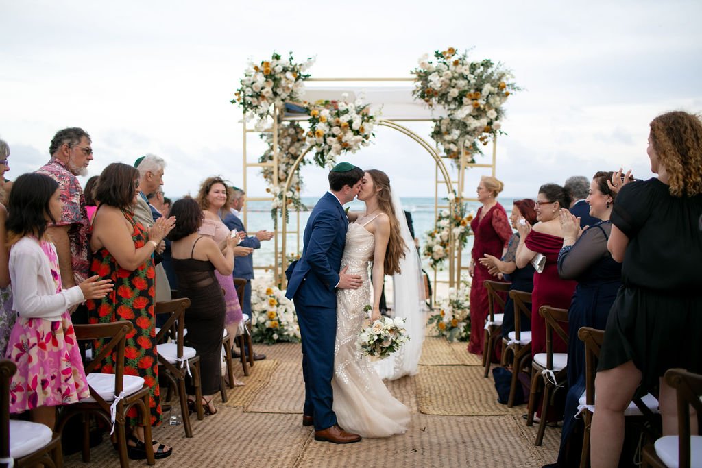 couple have grand jewish wedding ceremony on the sand in mexico