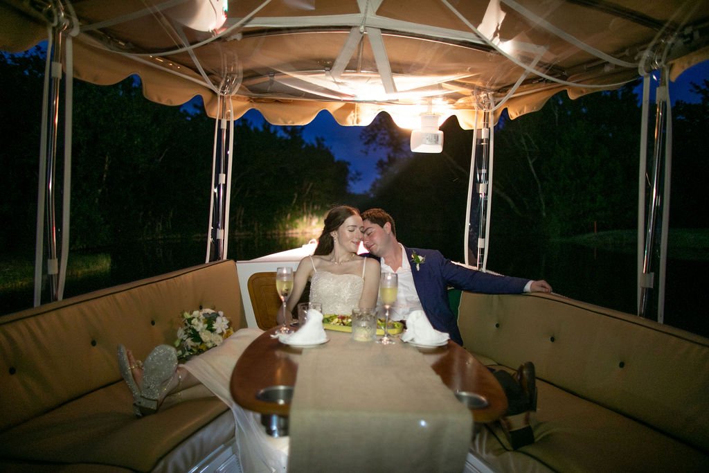 bride and groom on their boat ride before their wedding reception at banyan tree mayakoba in mexico