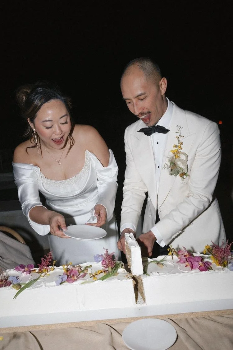 bride and groom cutting the cake during their destination wedding weekend
