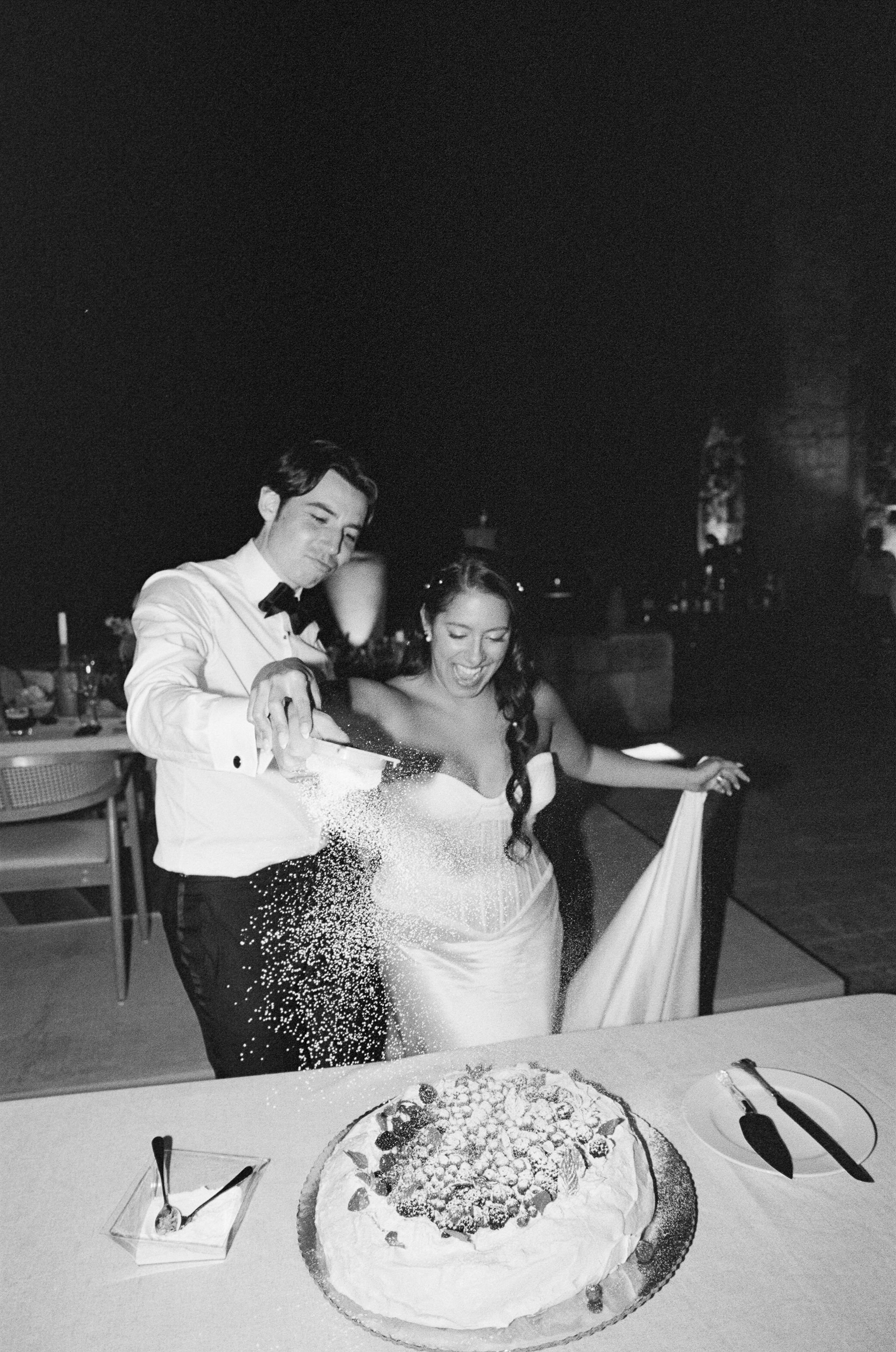 bride and groom cut the cake at their destination wedding in mexico