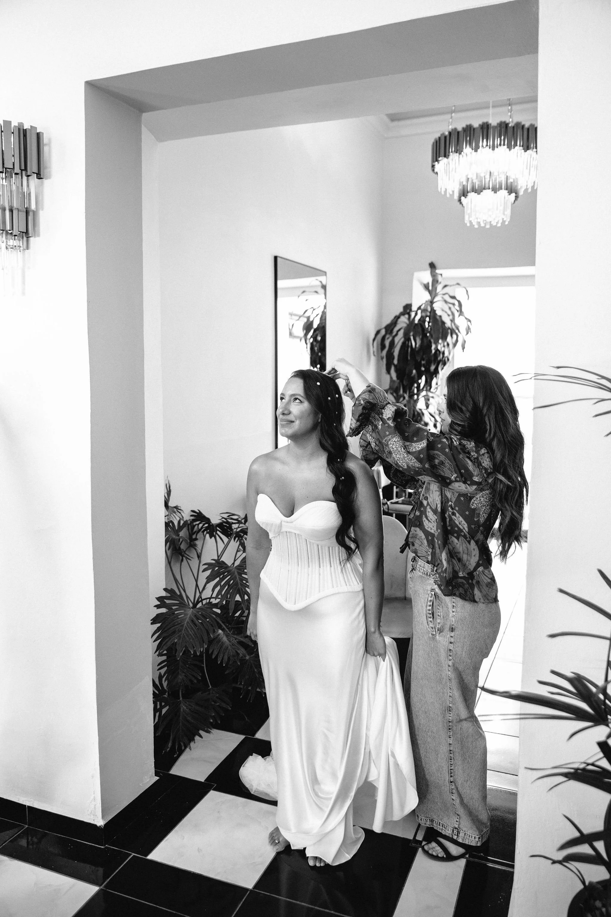 destination hair and makeup artist positions bride's hair before she walks down the aisle in mexico