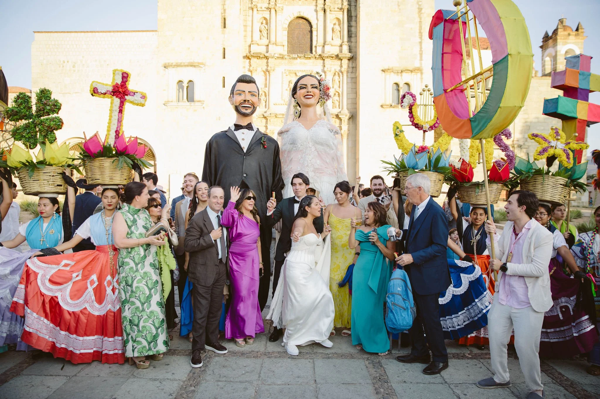 Oaxaca wedding traditional Calenda, a vibrant street parade with brass bands, fireworks, dancing, giant puppets, and mezcal