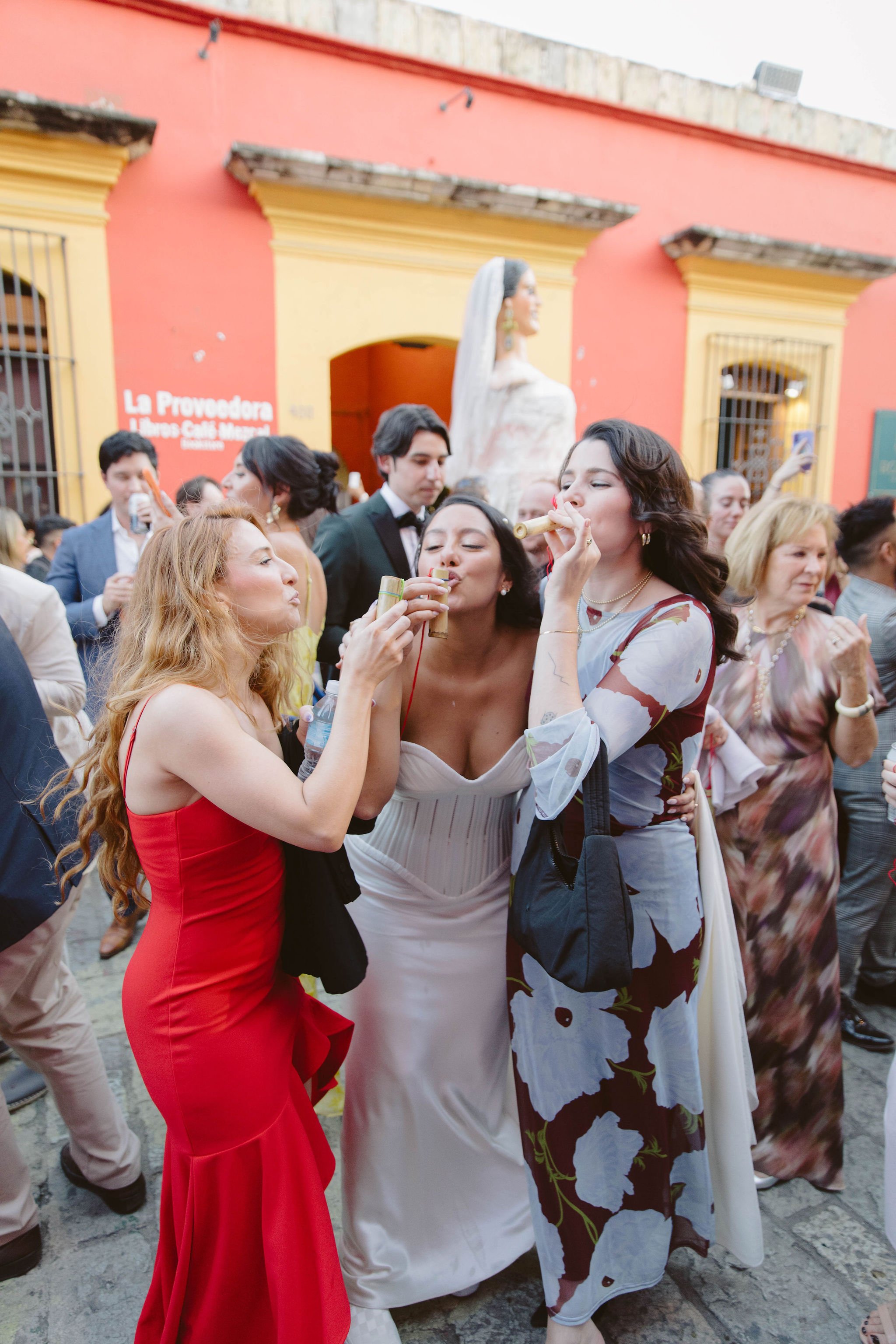 bride takes shots of mezcal while dancing in the streets of oaxaca