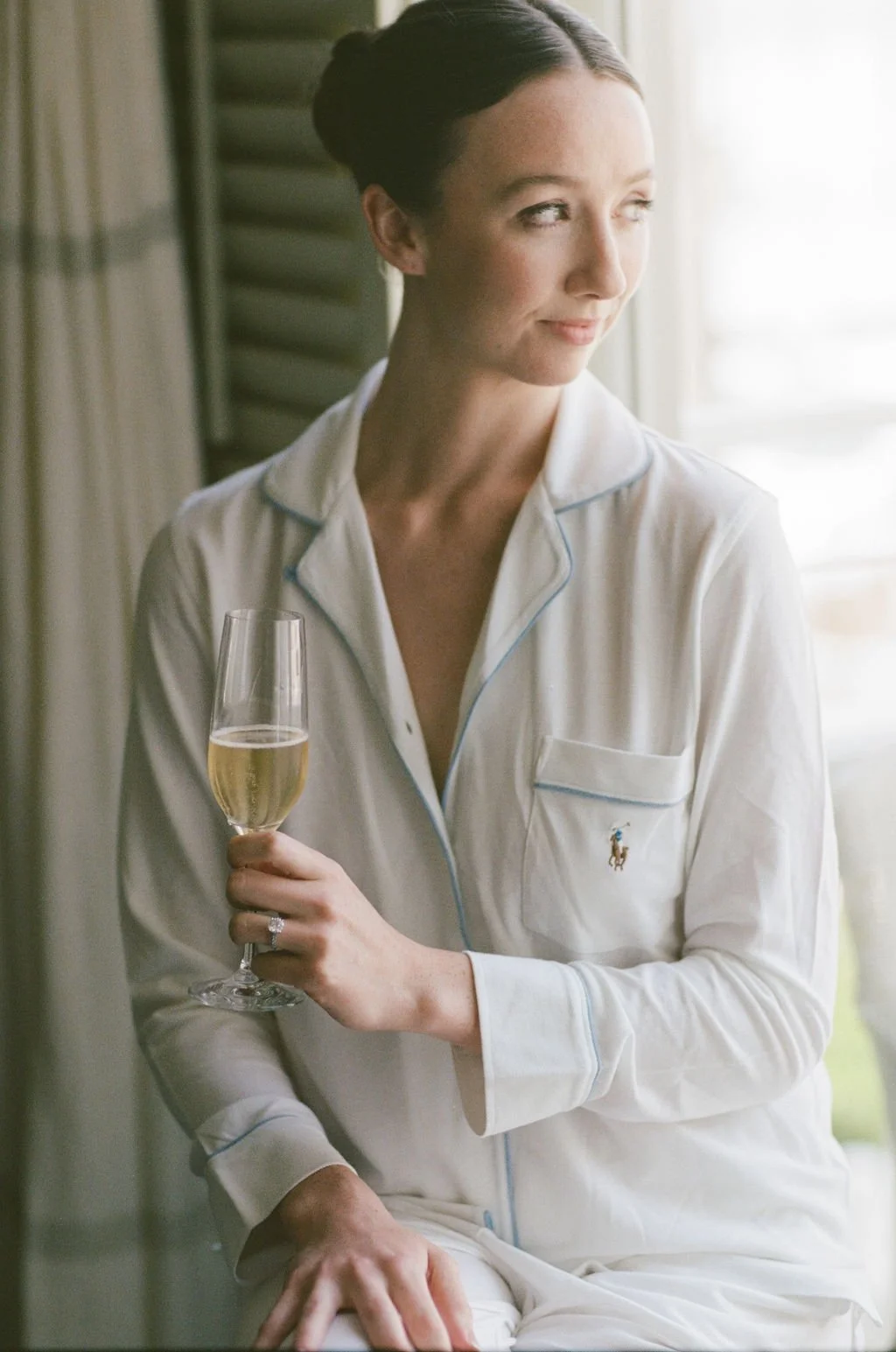 bride getting ready for her wedding day with a glass of champagne